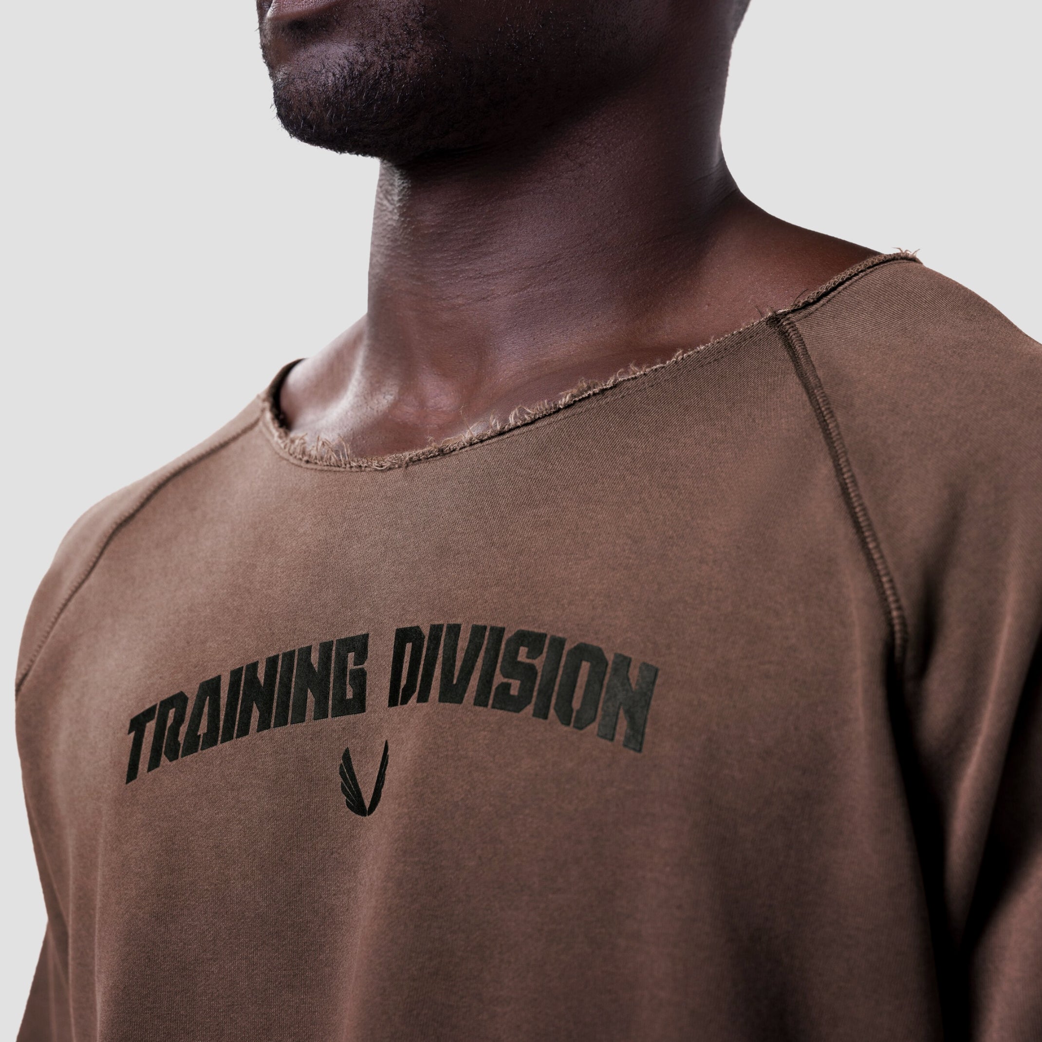 Vintage Raw Hem Pump Cover in brown, worn by model showing chest graphic detail