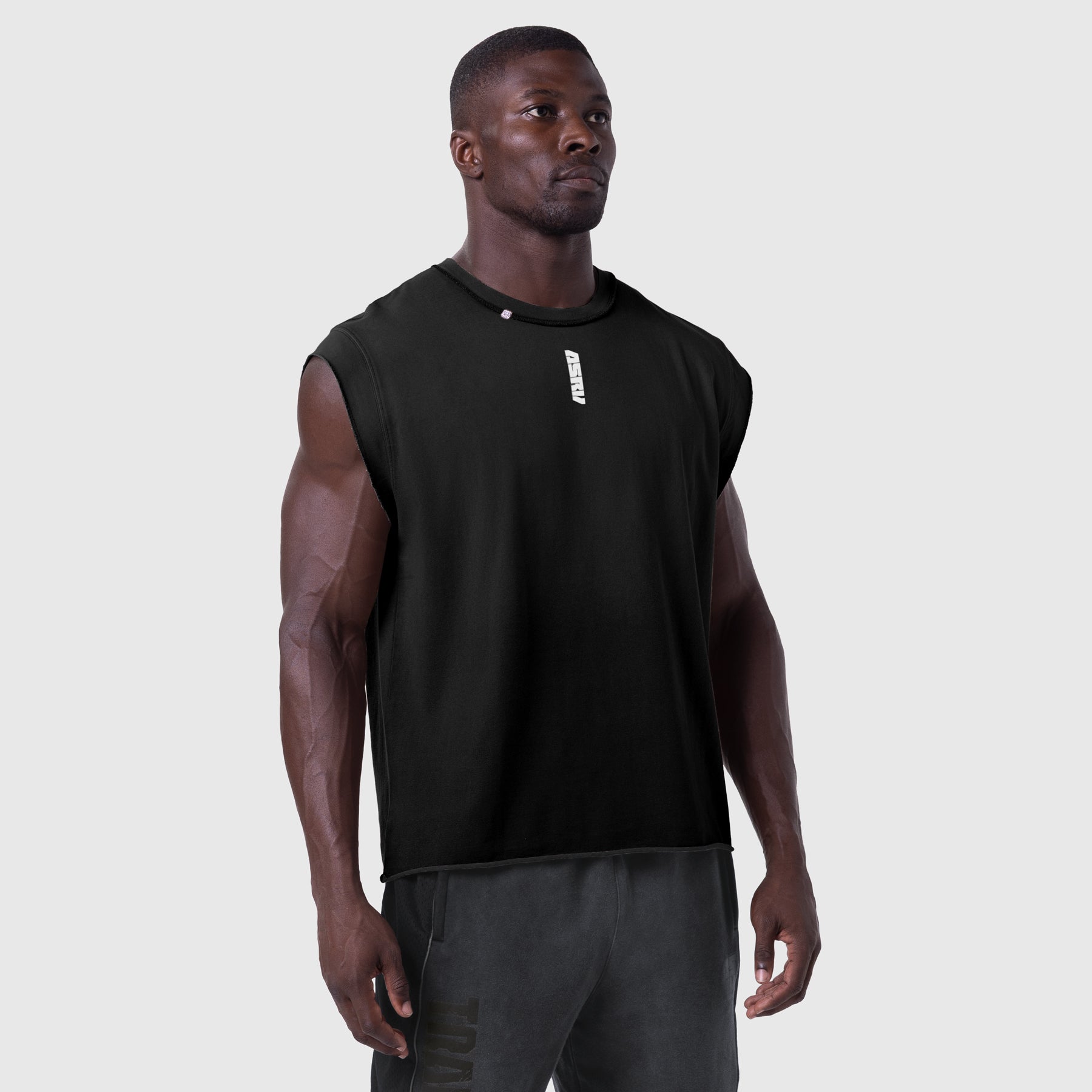 Black Tech Essential Cap Shoulder Cutoff tank top worn by model, front view