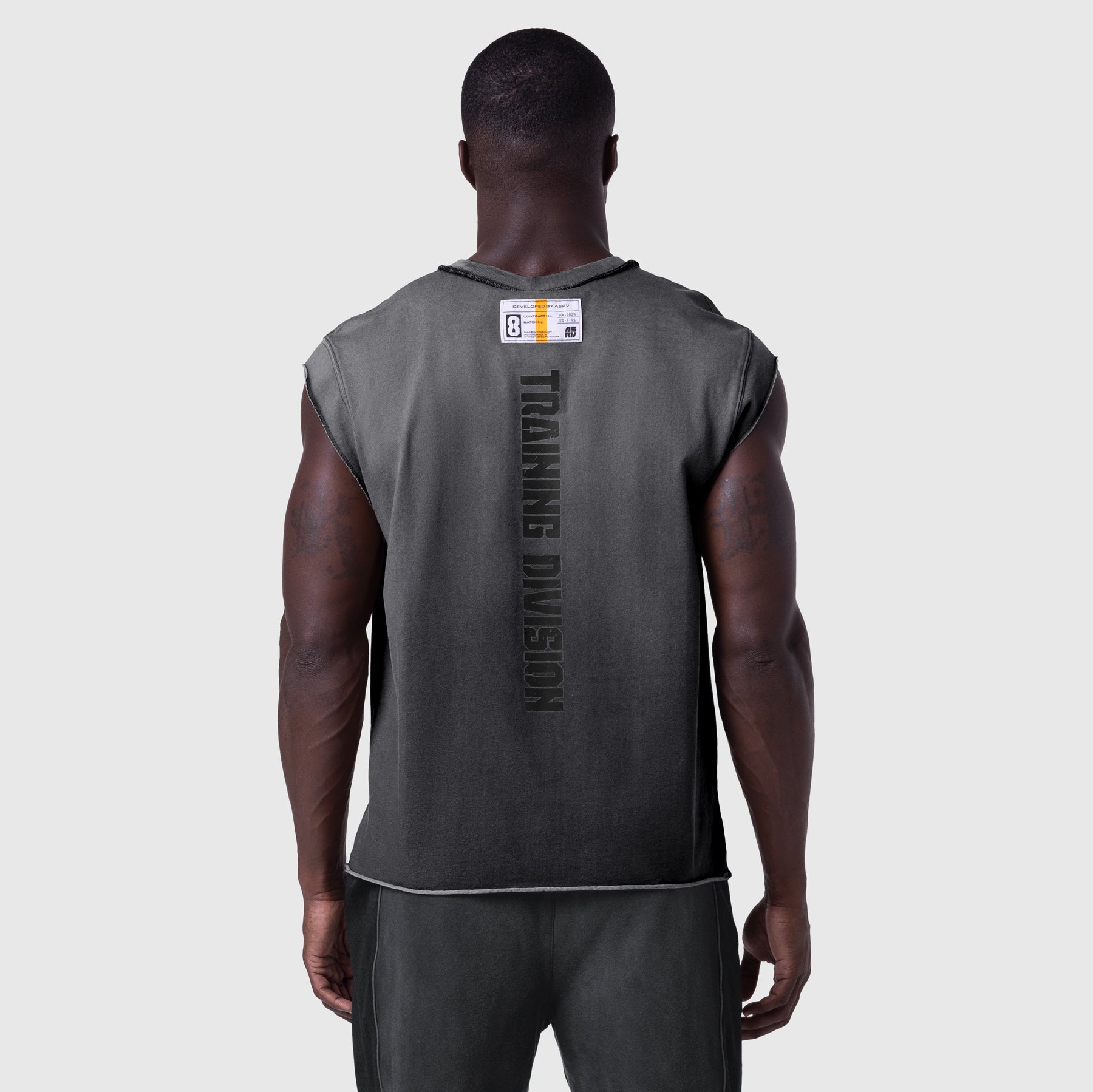 Tech Essential Cap Shoulder Cutoff tank in black sun fade, back view on model