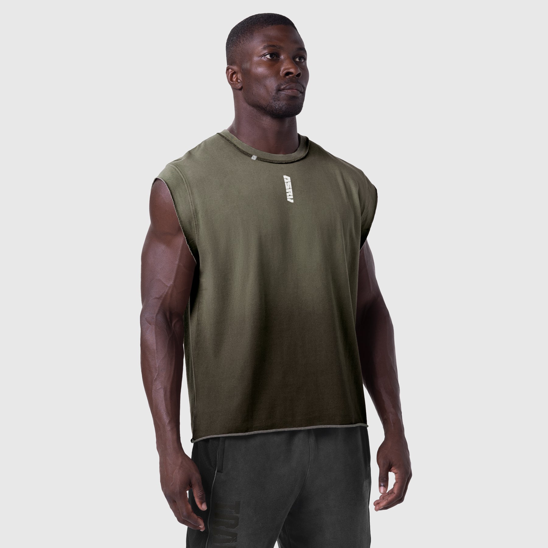Tech Essential Cap Shoulder Cutoff in olive, worn by model, front view