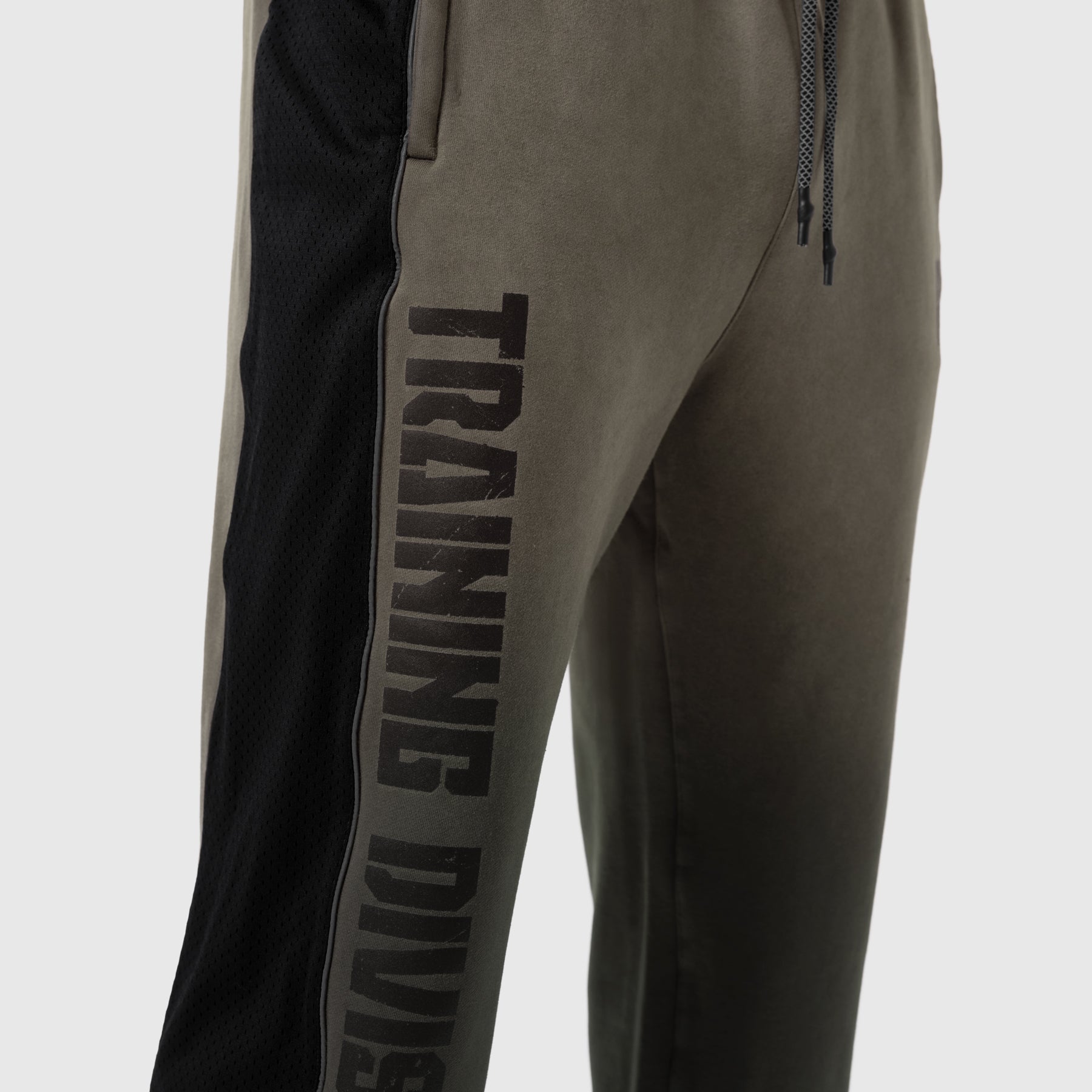 Tech-Terry Mesh Panel Sweats in olive with black mesh panels, worn by model, side view
