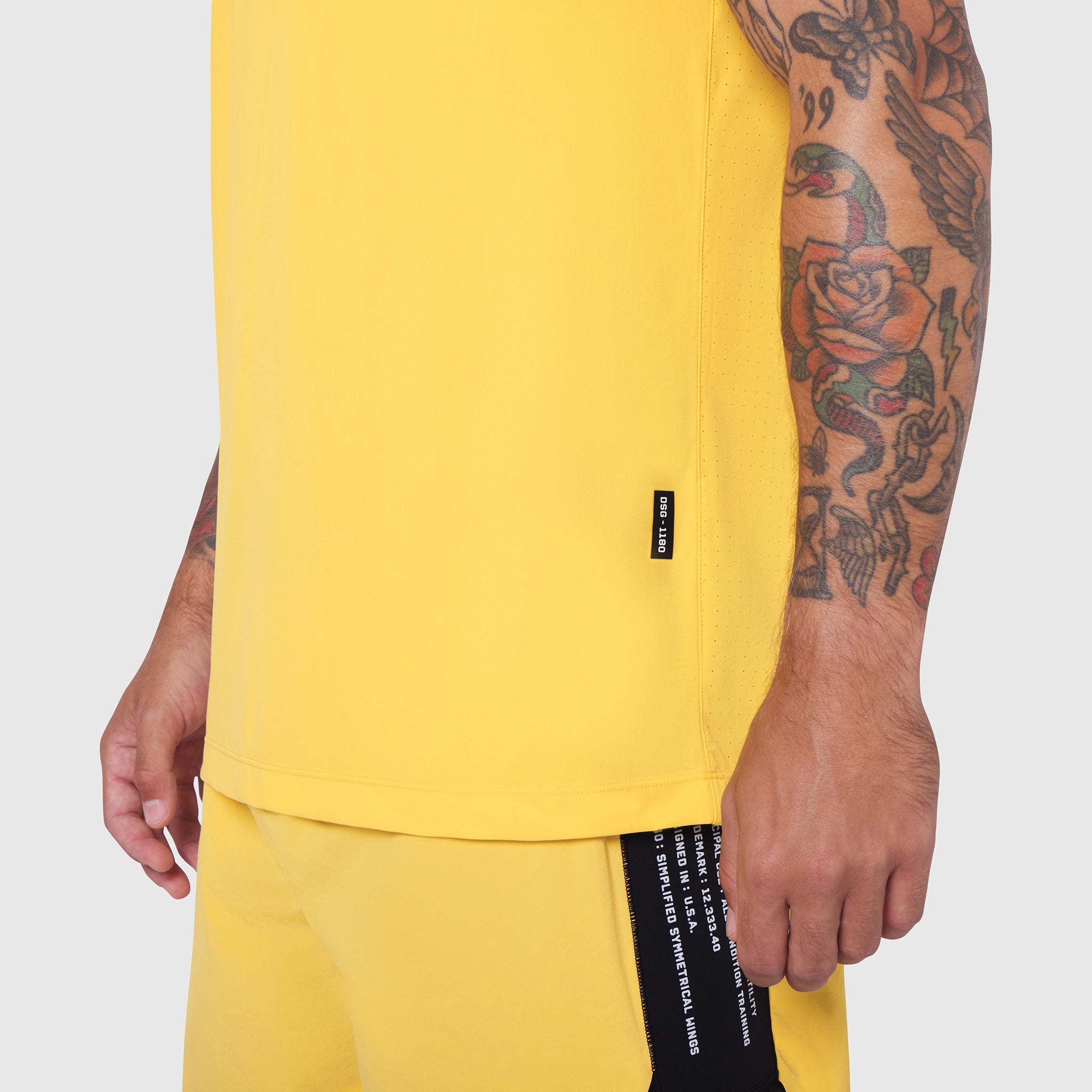 Laser-Vent™ Training Tee in amber yellow worn by tattooed model, side view