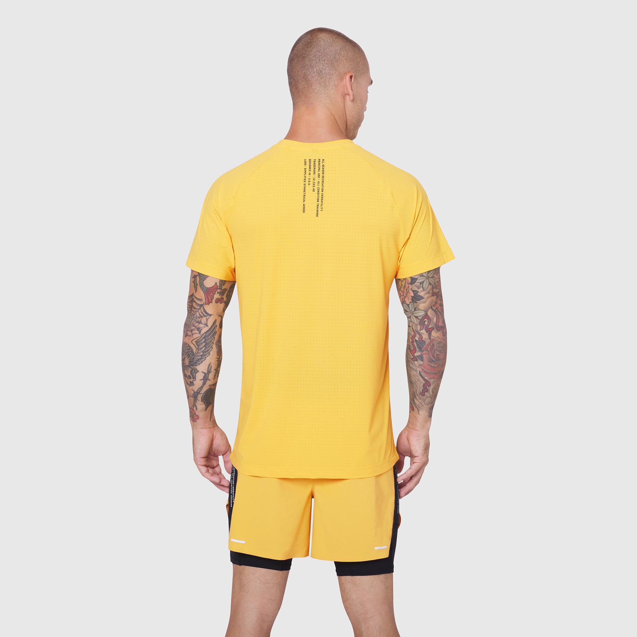 Laser-Vent Training Tee in amber yellow worn by model, back view