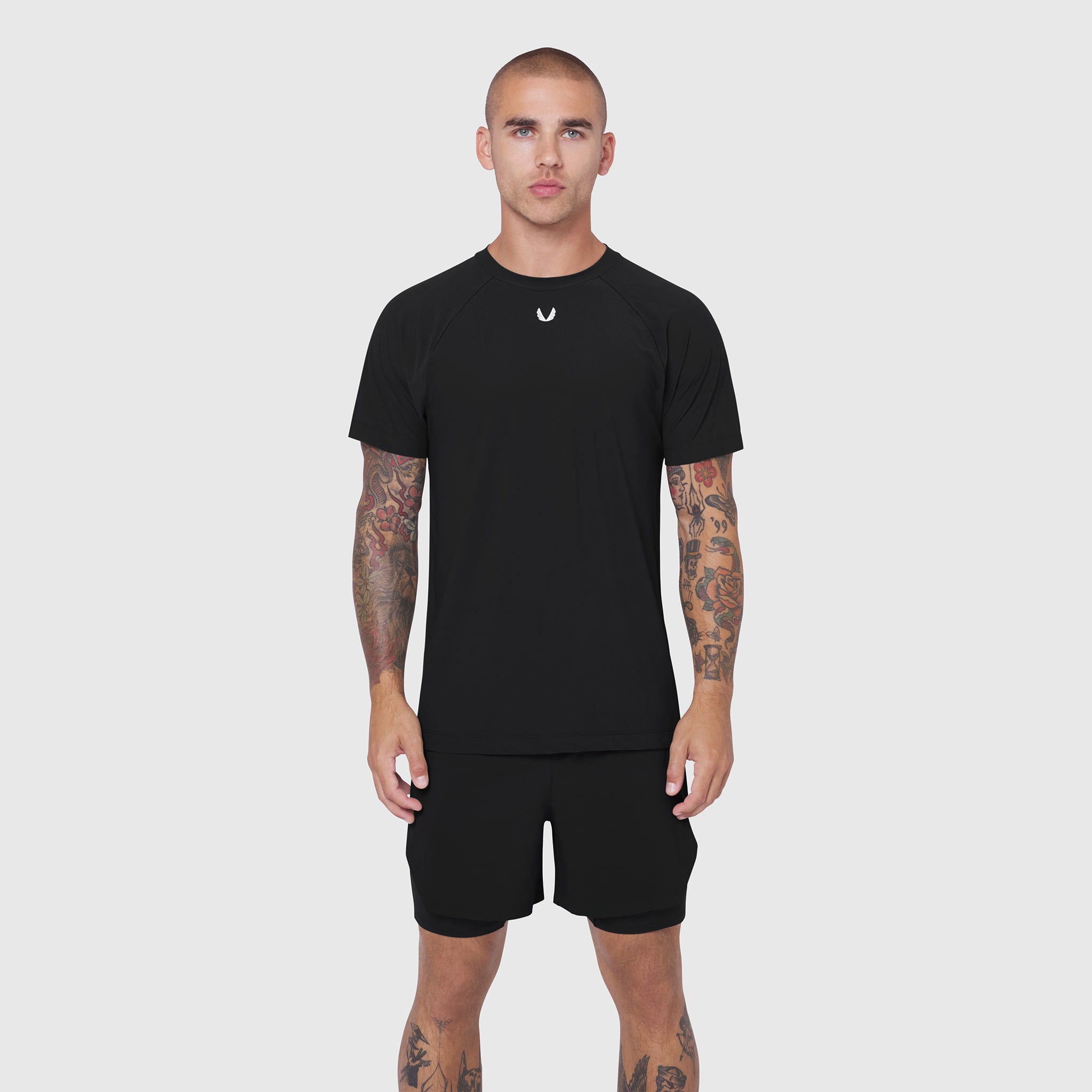 Black Laser-Vent Training Tee worn by model, front view, paired with black shorts