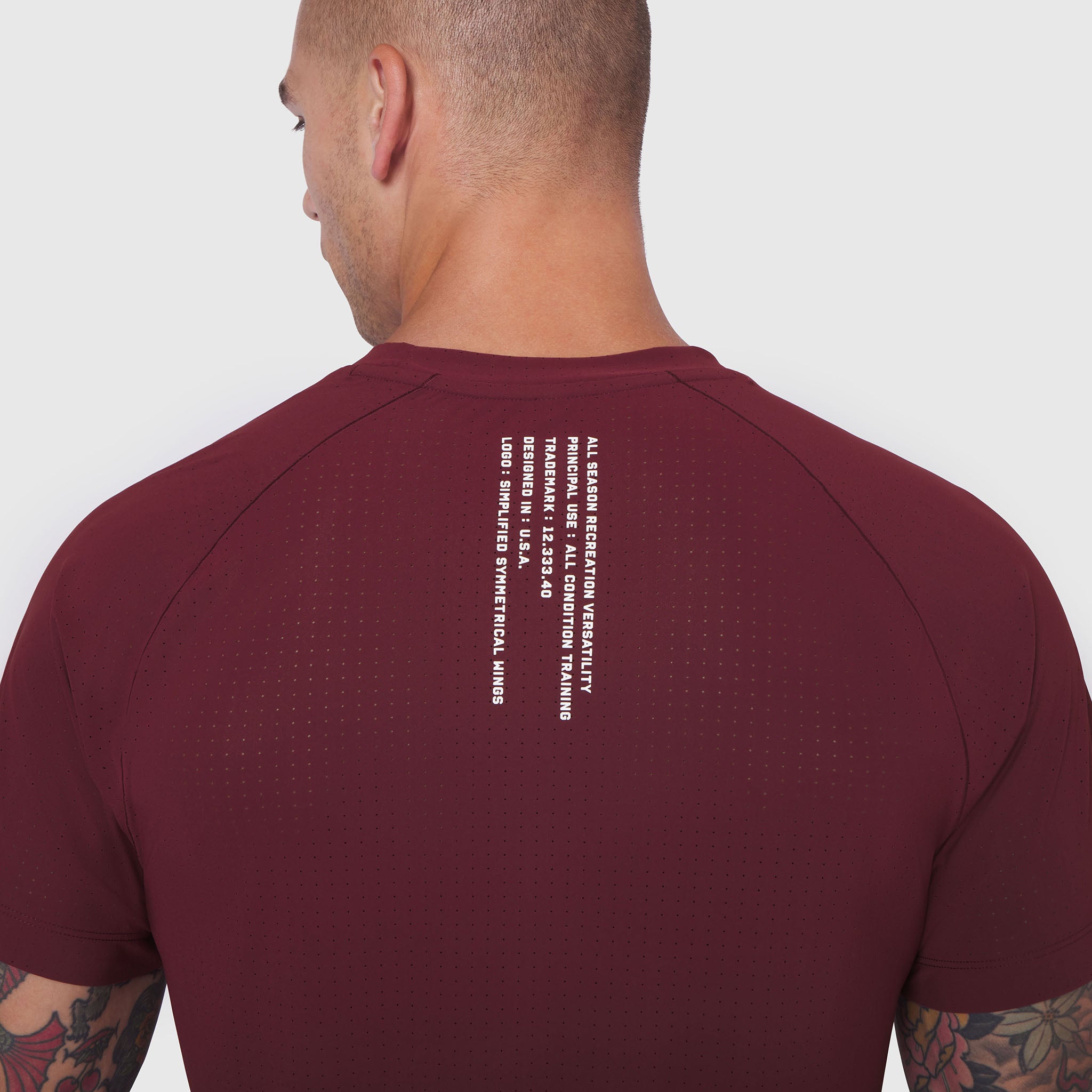 Laser-Vent Training Tee in crimson worn by model, back view showing text detail
