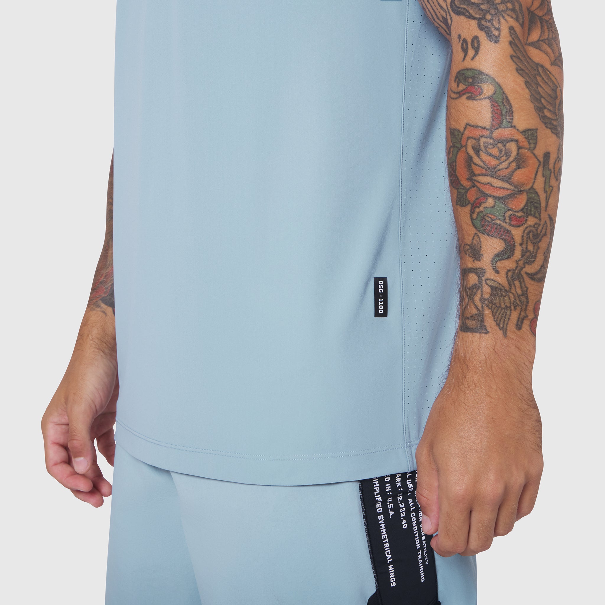 Laser-Vent Training Tee in light sky worn by model showing side view and fit