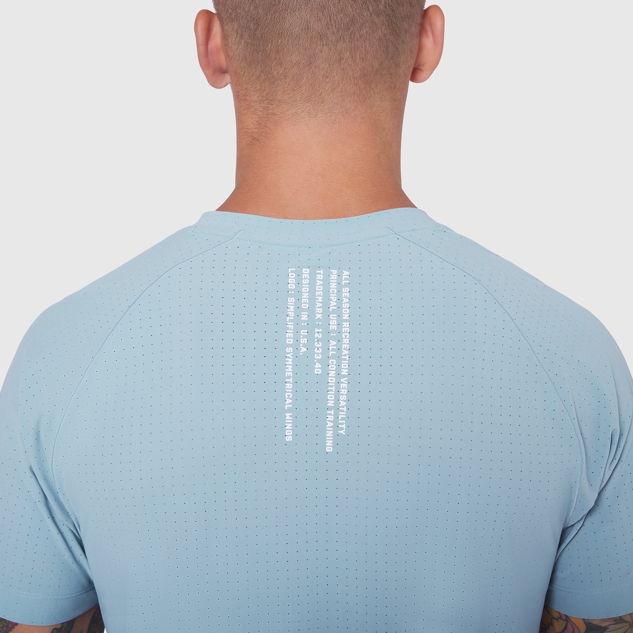 Light Sky Laser-Vent Training Tee worn by model, back view showing perforated fabric detail