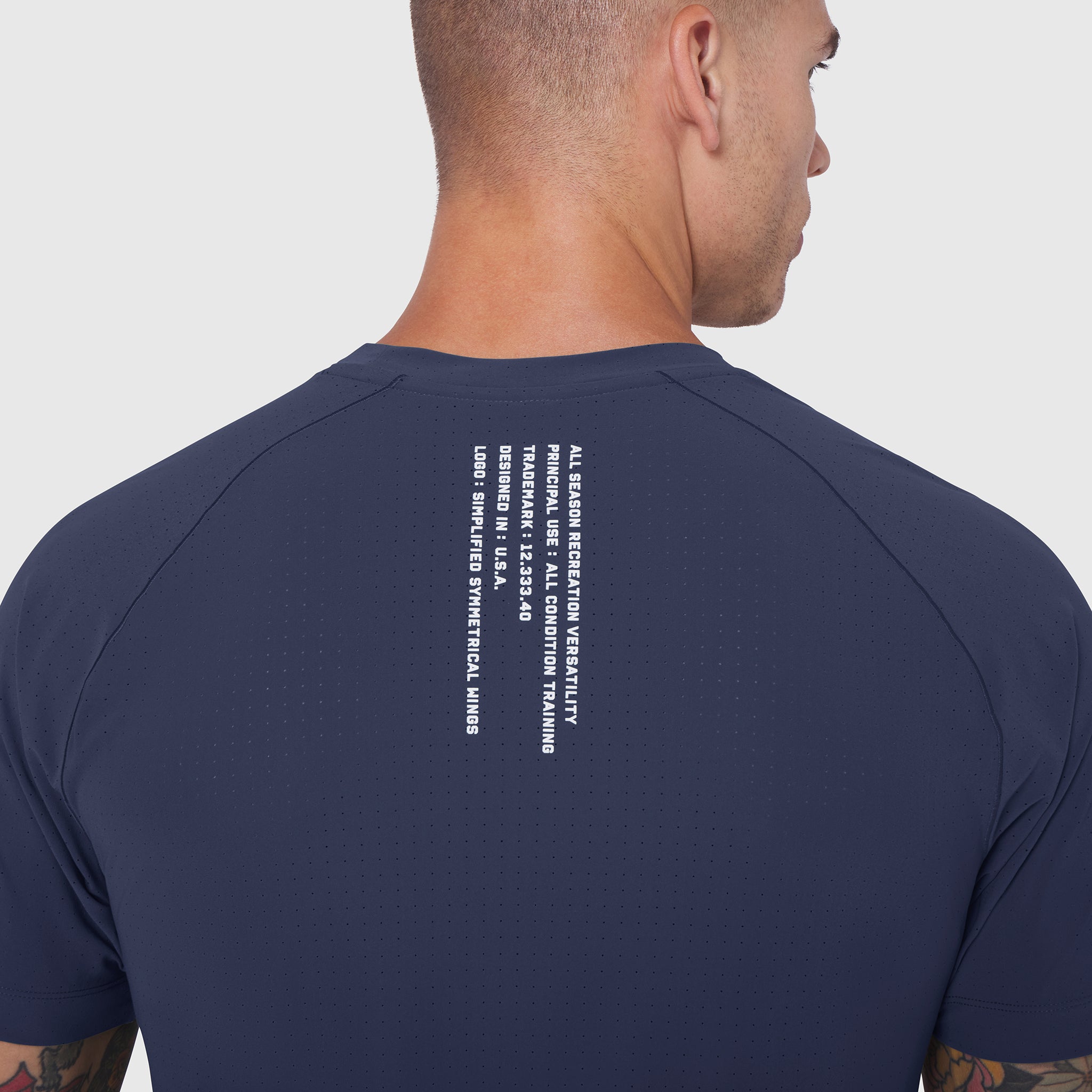 Laser-Vent™ Training Tee in navy worn by model, back view showing text detail