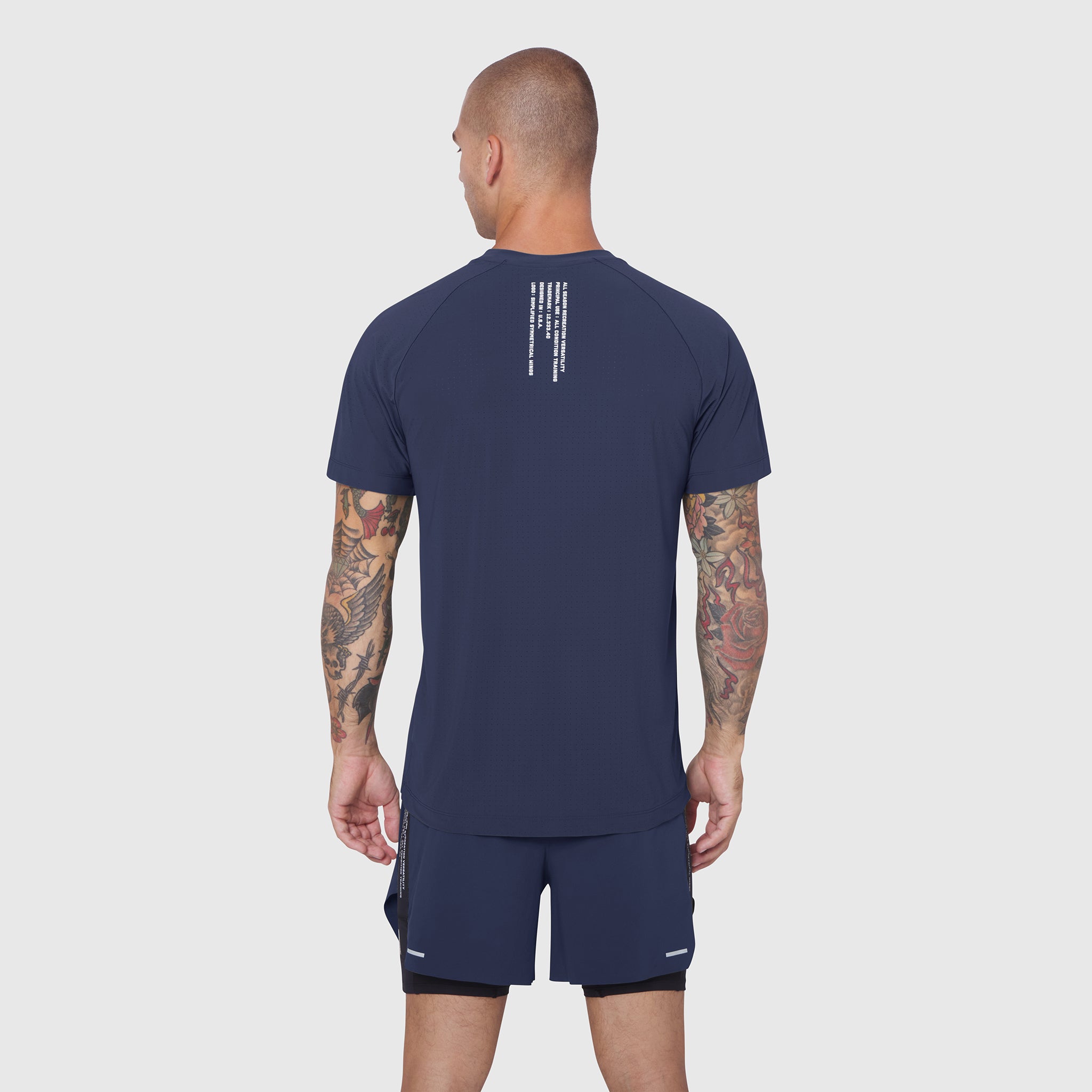 Laser-Vent Training Tee in navy, back view on model with tattoos