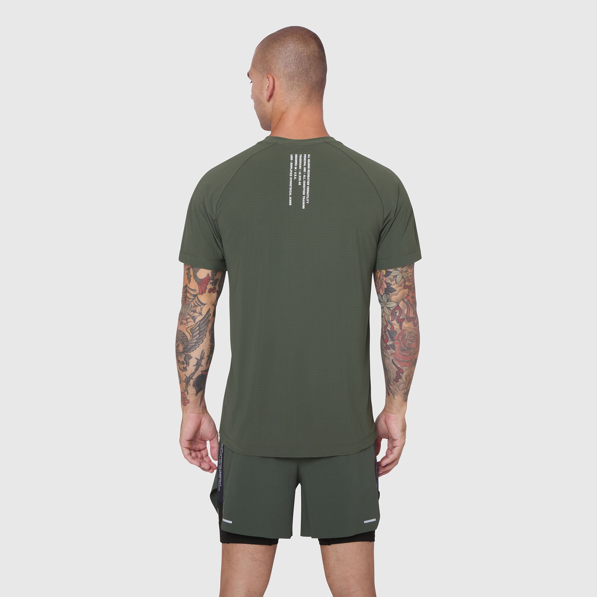 Laser-Vent™ Training Tee in olive worn by model, back view showing rear graphic