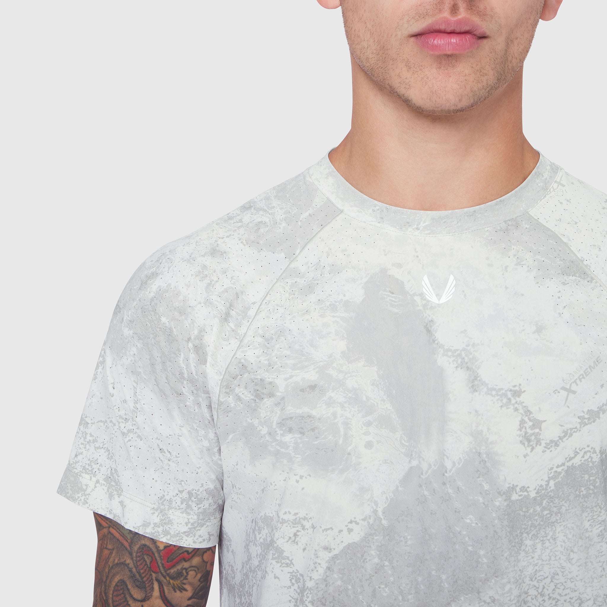 Laser-Vent Training Tee in white acid wash, worn by model showing front view