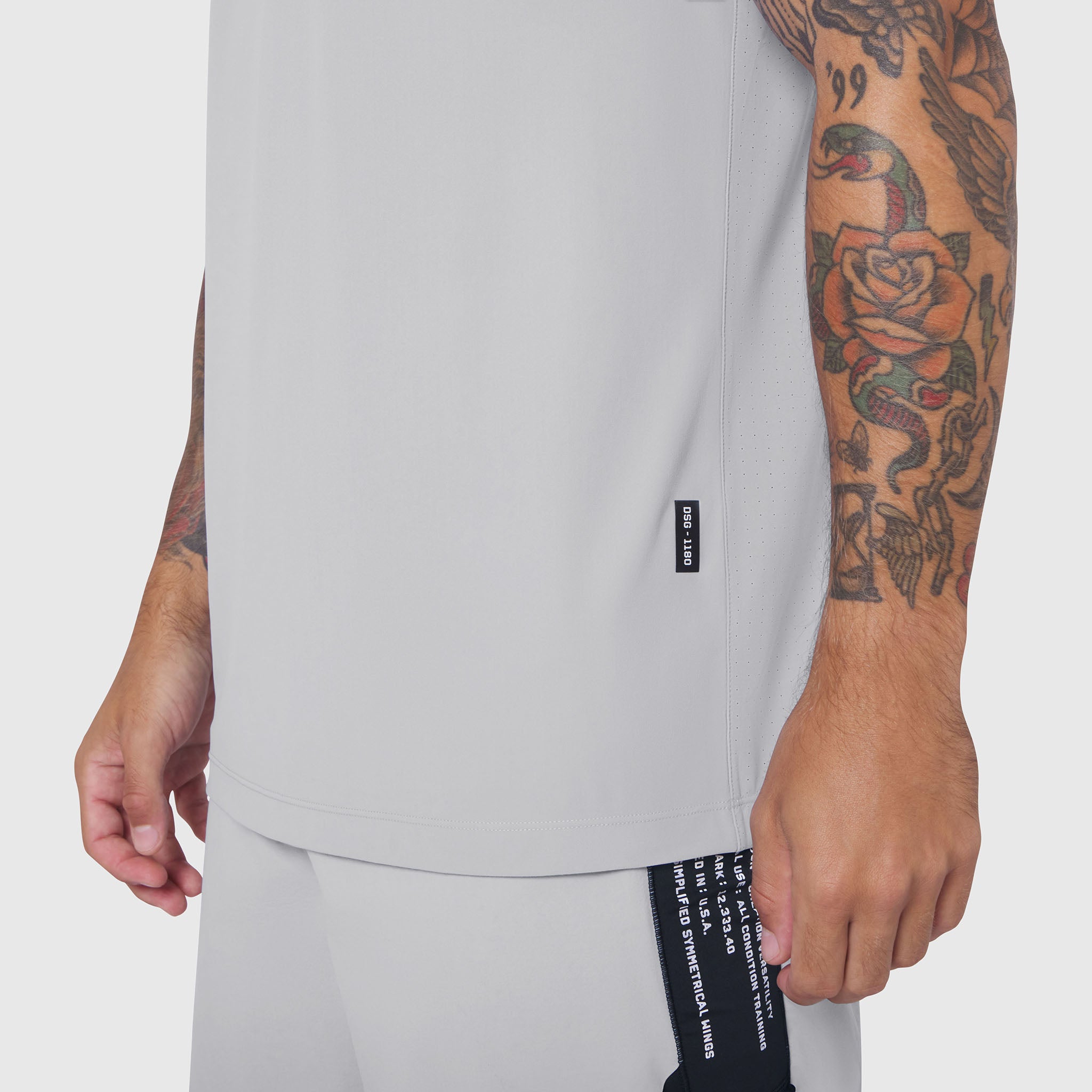 Laser-Vent Training Tee in white worn by tattooed model, side view