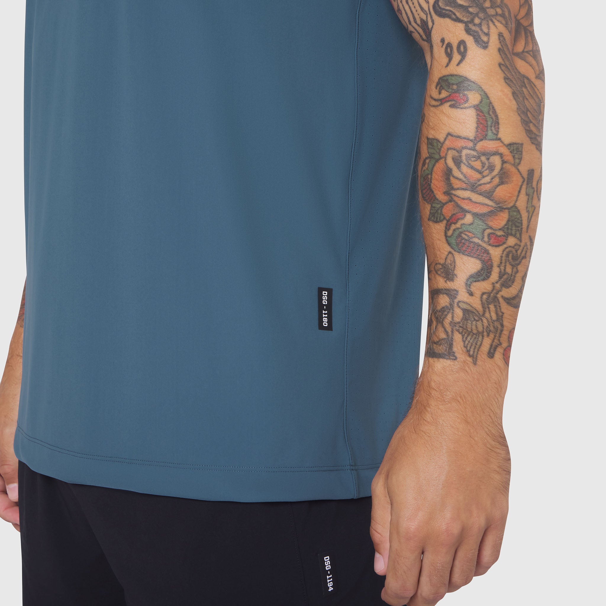 Laser-Vent Training Tee in storm blue worn by tattooed model, side view
