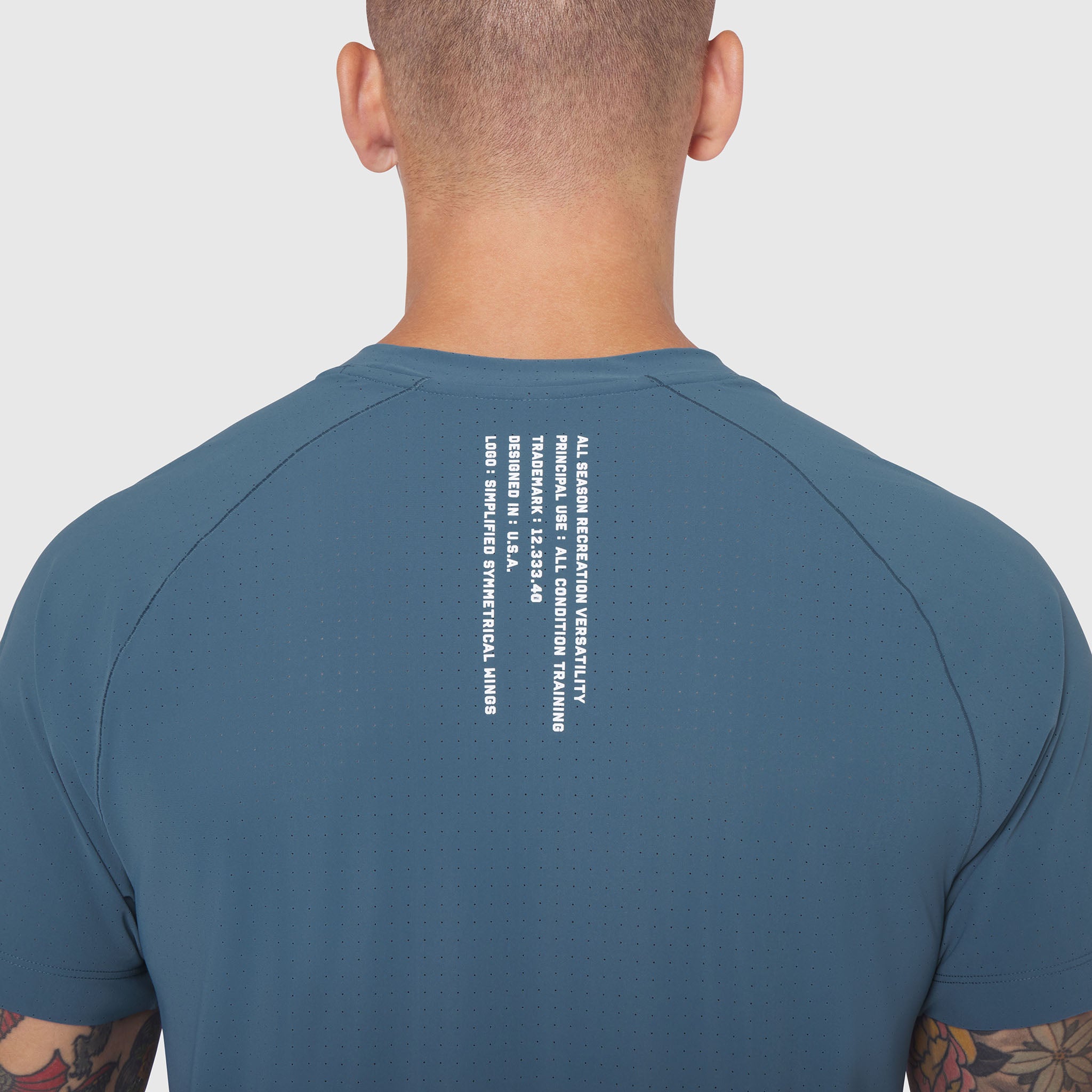 Laser-Vent Training Tee in storm blue, back view on model showing text detail
