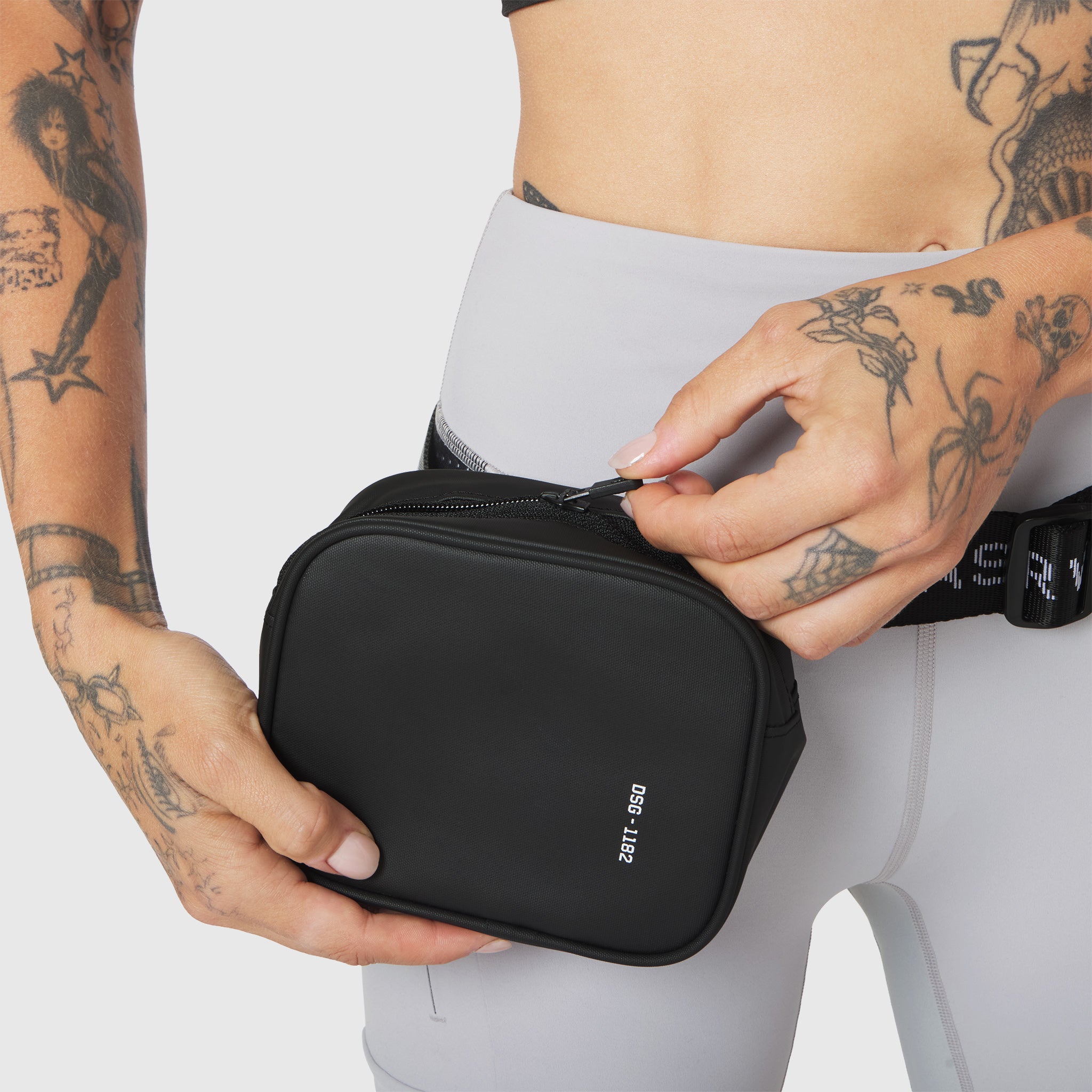 Trail Pack in black, held by model wearing gray athletic wear