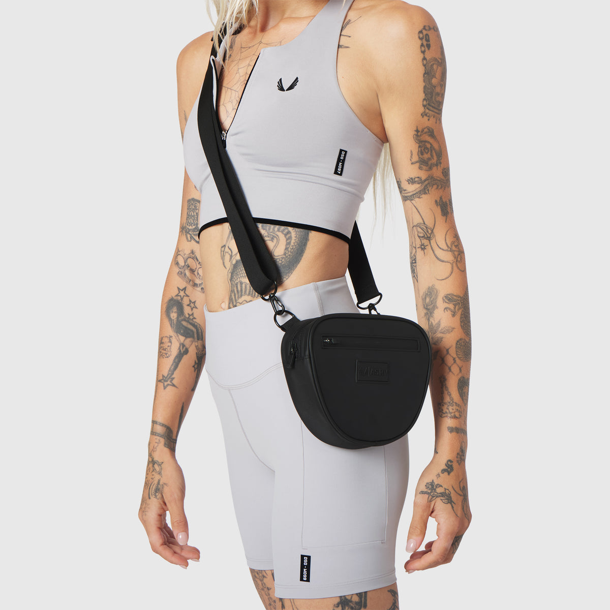Trail Pack in black, worn as crossbody bag on model