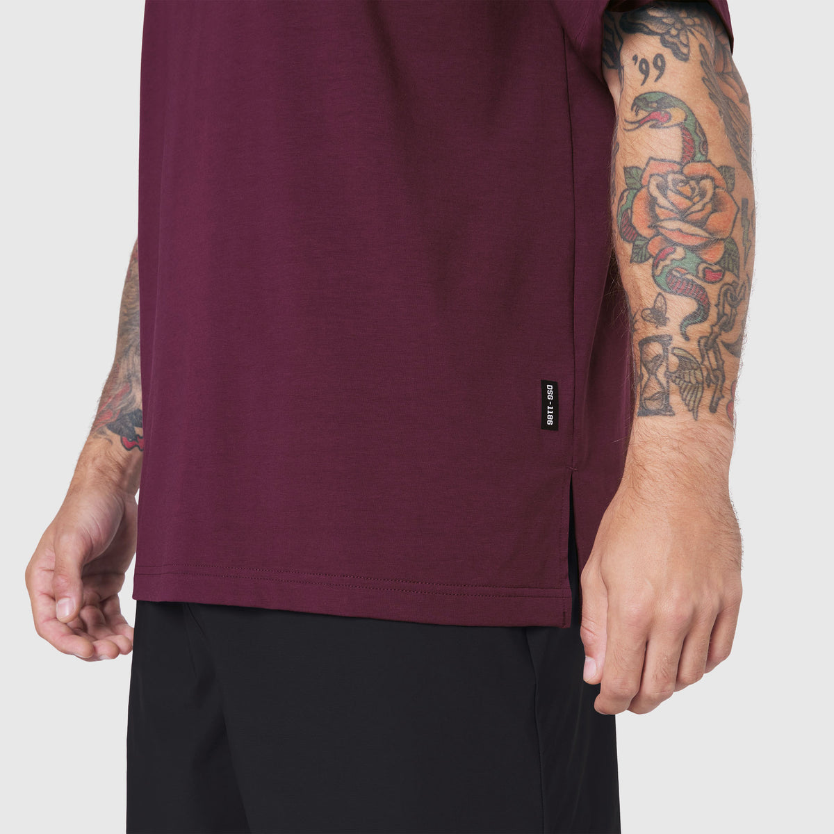 Supima Ice-Skin Reversible Tee in Merlot worn by model, side view showing tattoos