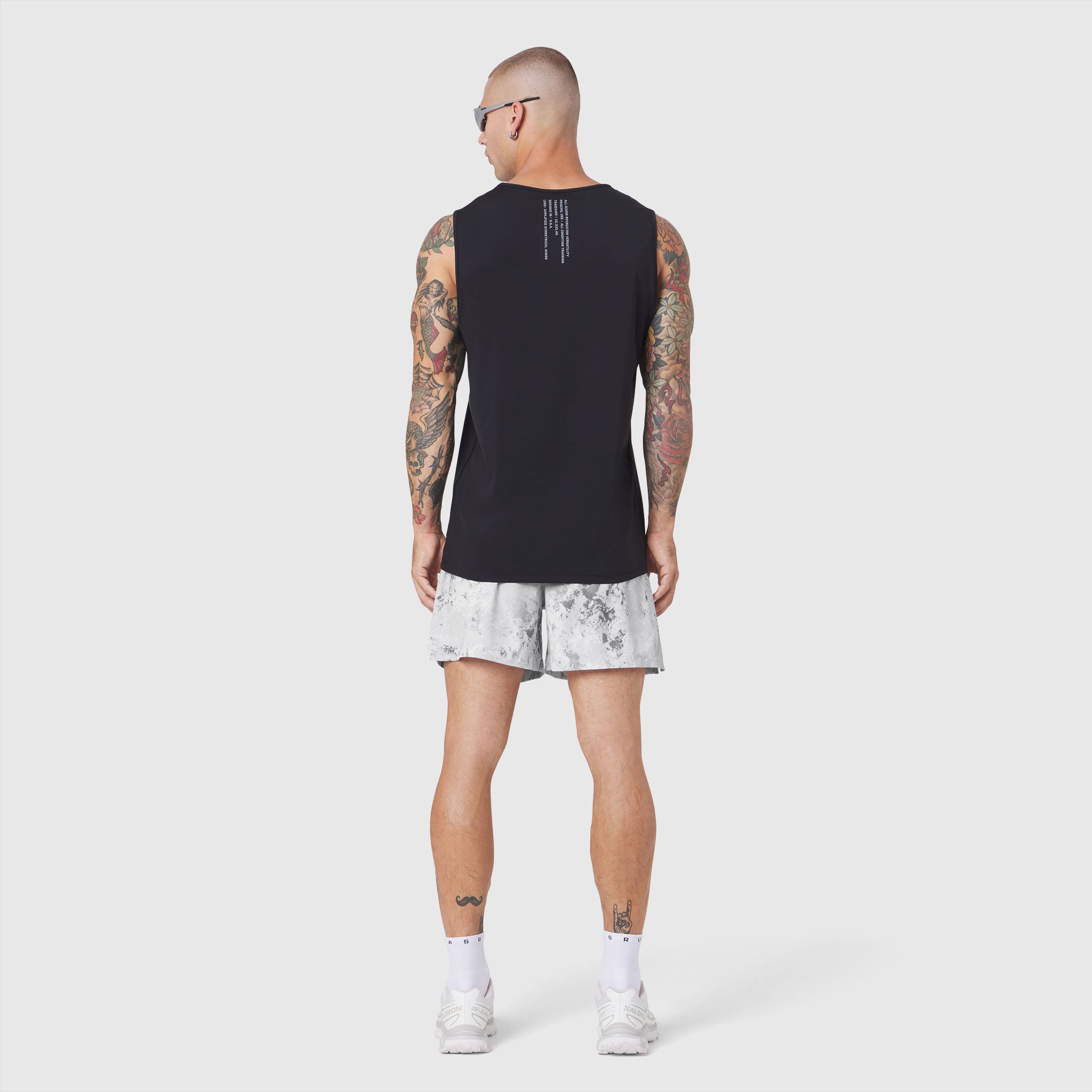 Black Warpflexx-Lite Training Tank worn with white shorts, back view on model