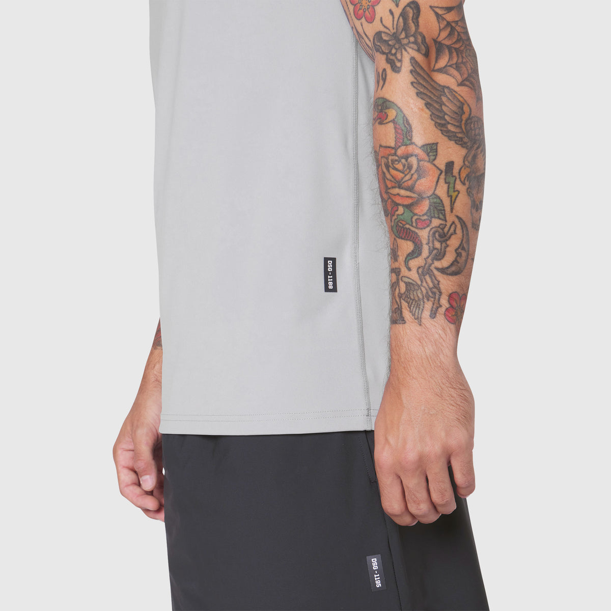 Warpflexx-Lite Training Tank in white, worn by model showing side view and sleeve detail