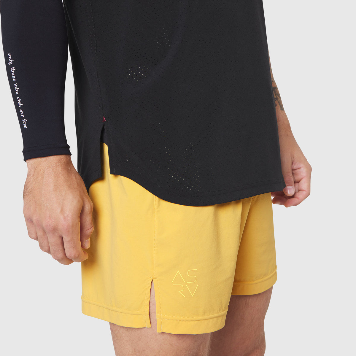Aerotex Perforated Run Tank in black worn with yellow shorts, side view detail