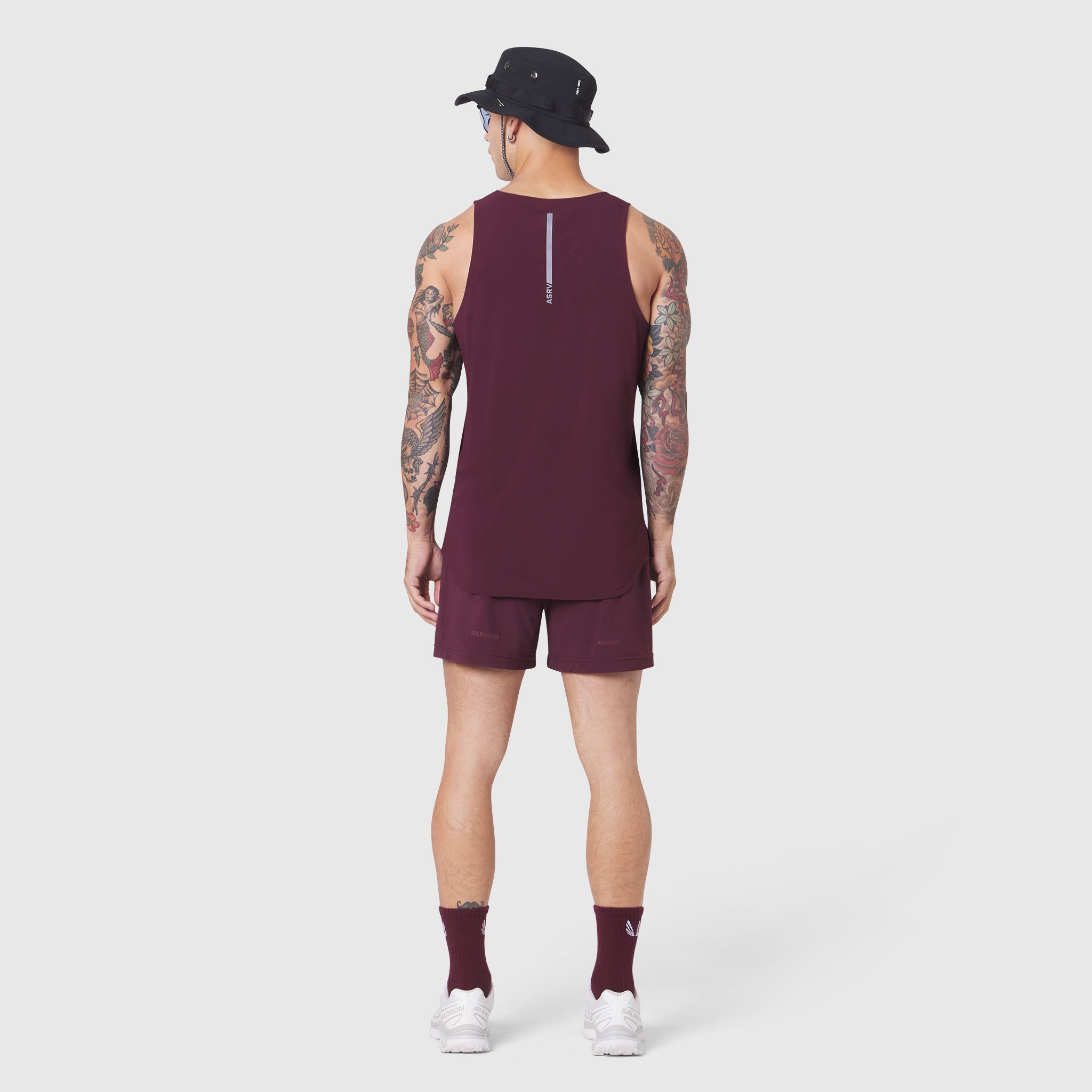 Aerotex Perforated Run Tank in merlot, back view on model with matching shorts