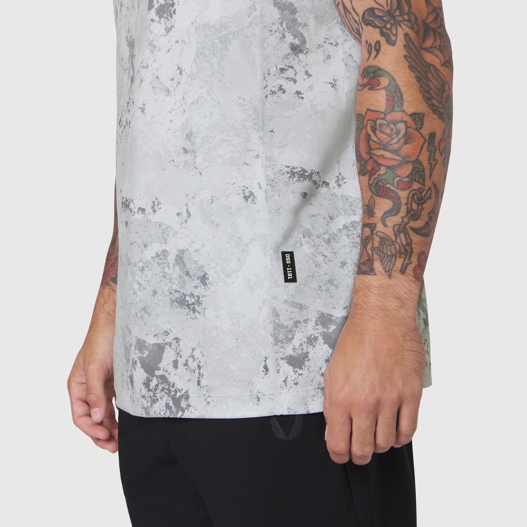 AEROSILVER® UPF50+ Run Tee in Sedona Snow Camo worn by tattooed model, side view