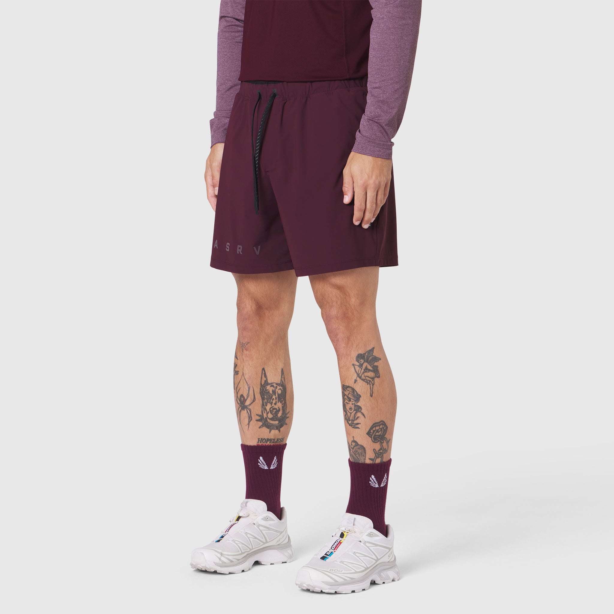 Revolutional Training Short in merlot worn by model with white sneakers and maroon socks