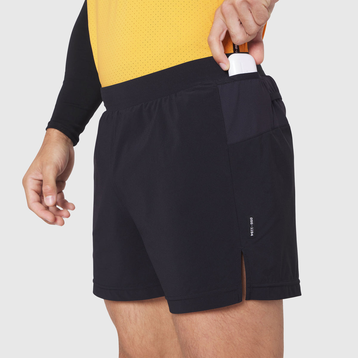 Aerotex™ Distance Run Short in black, worn by model with hand in pocket, side view