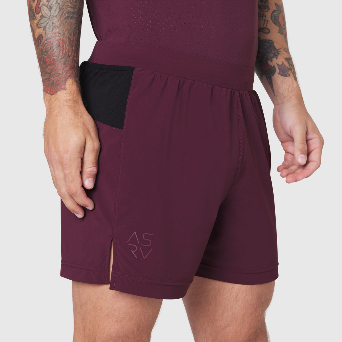 Aerotex Distance Run Short in merlot worn by model, side view showing pocket detail