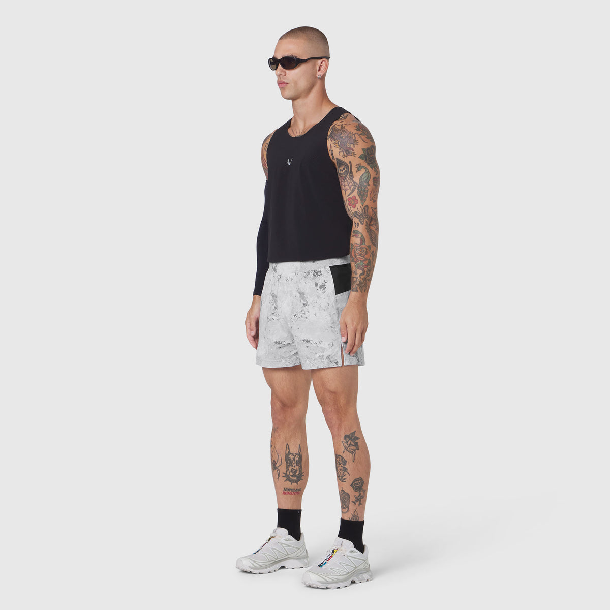 Aerotex Distance Run Short in Sedona Snow Camo worn with black sleeveless top, side view