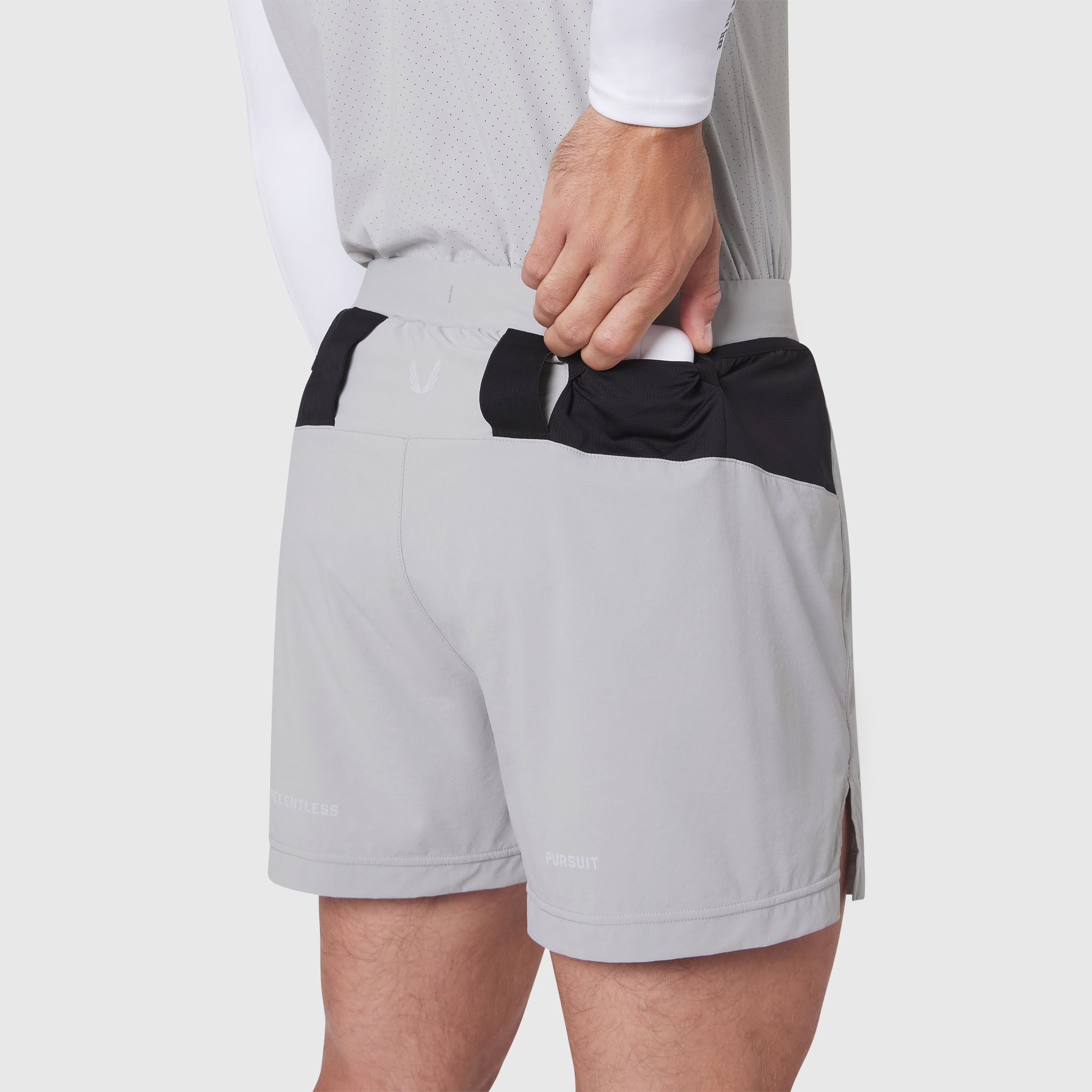 Aerotex Distance Run Short in slate grey, worn by model with hand in back pocket