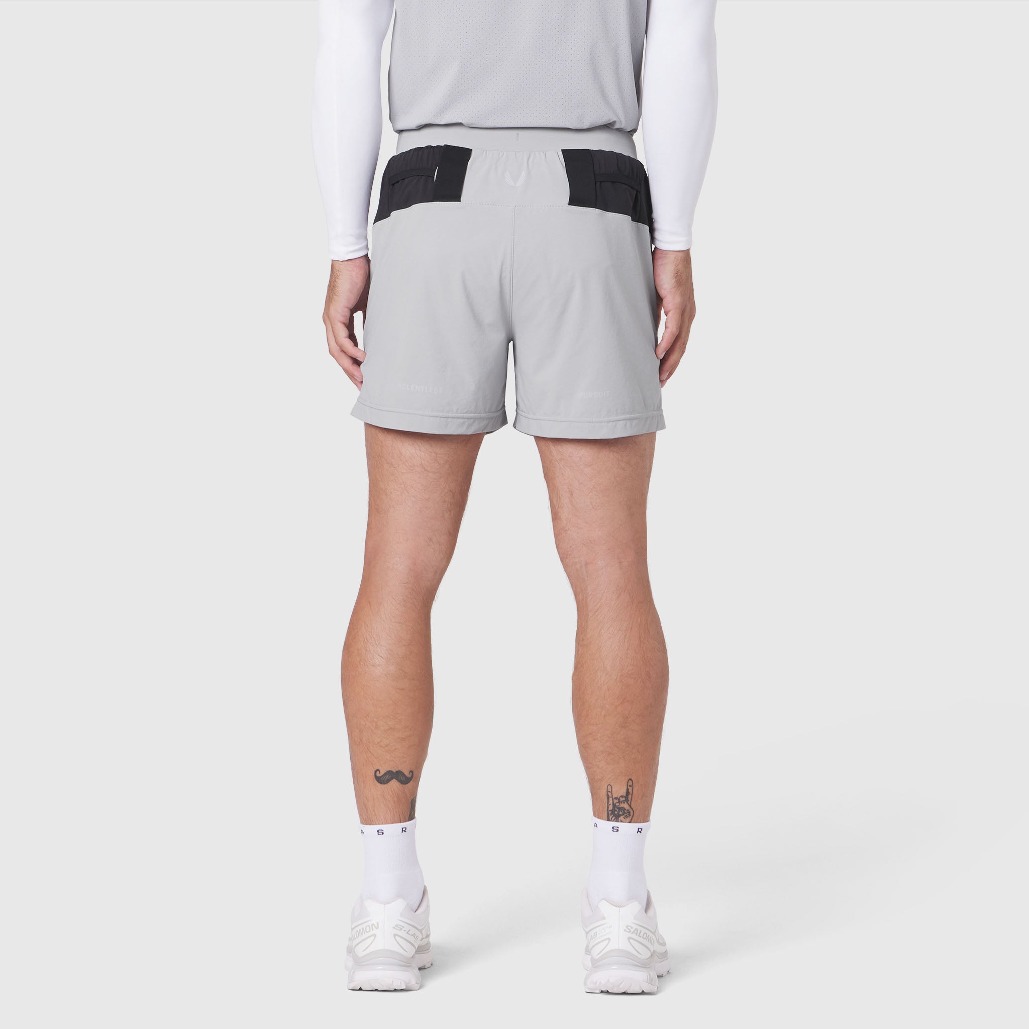 Aerotex Distance Run Short in slate grey with black waistband, rear view on model