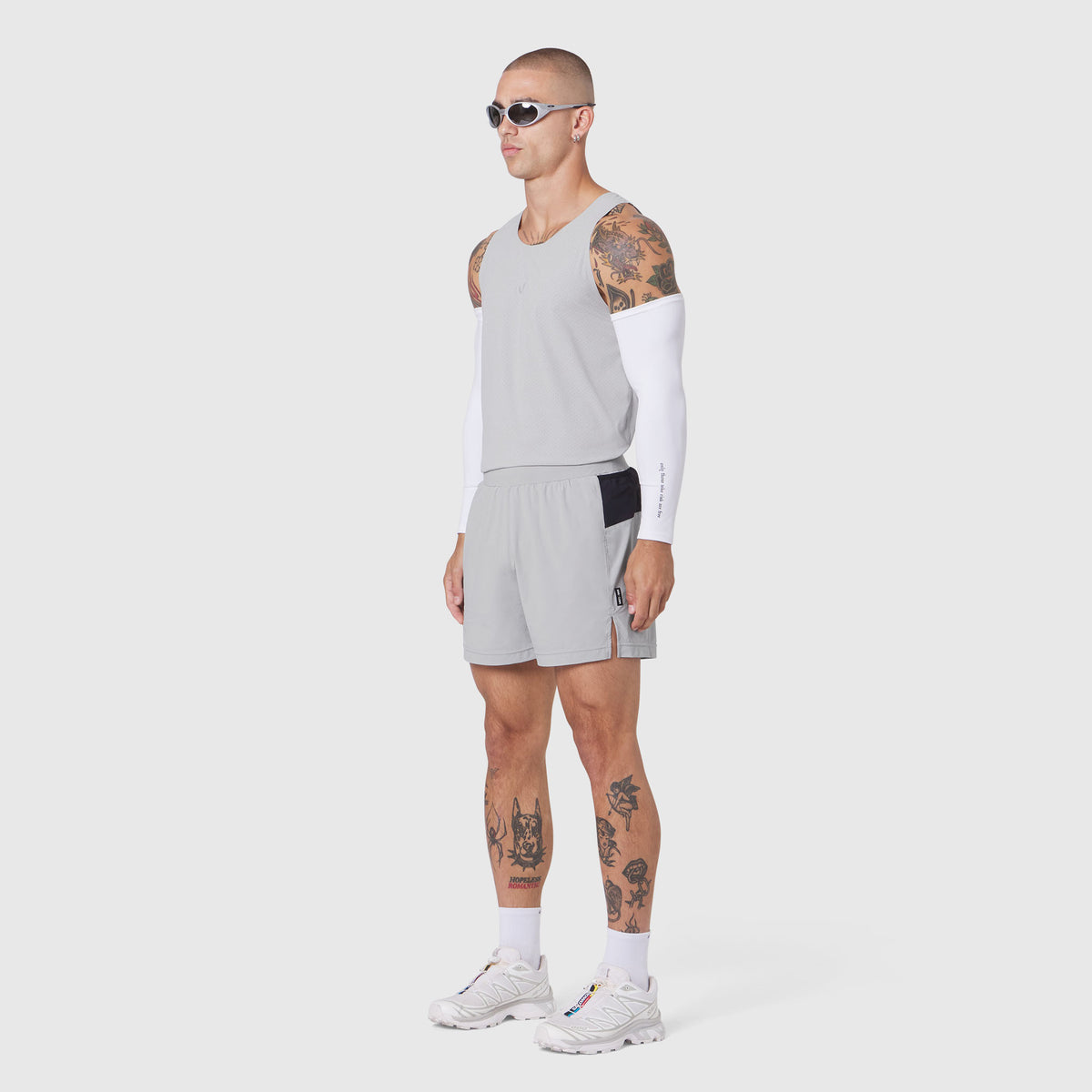Aerotex Distance Run Short in Slate Grey, modeled on male figure with white compression sleeve and white socks