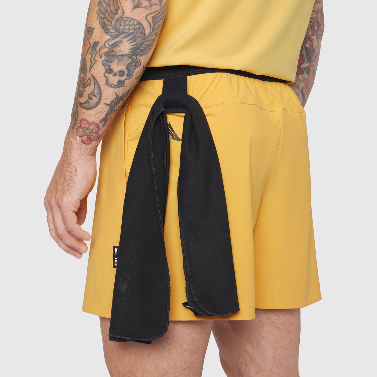 TETRA-LITE® 5" Linerless Training Short in Amber, model wearing shorts with black towel