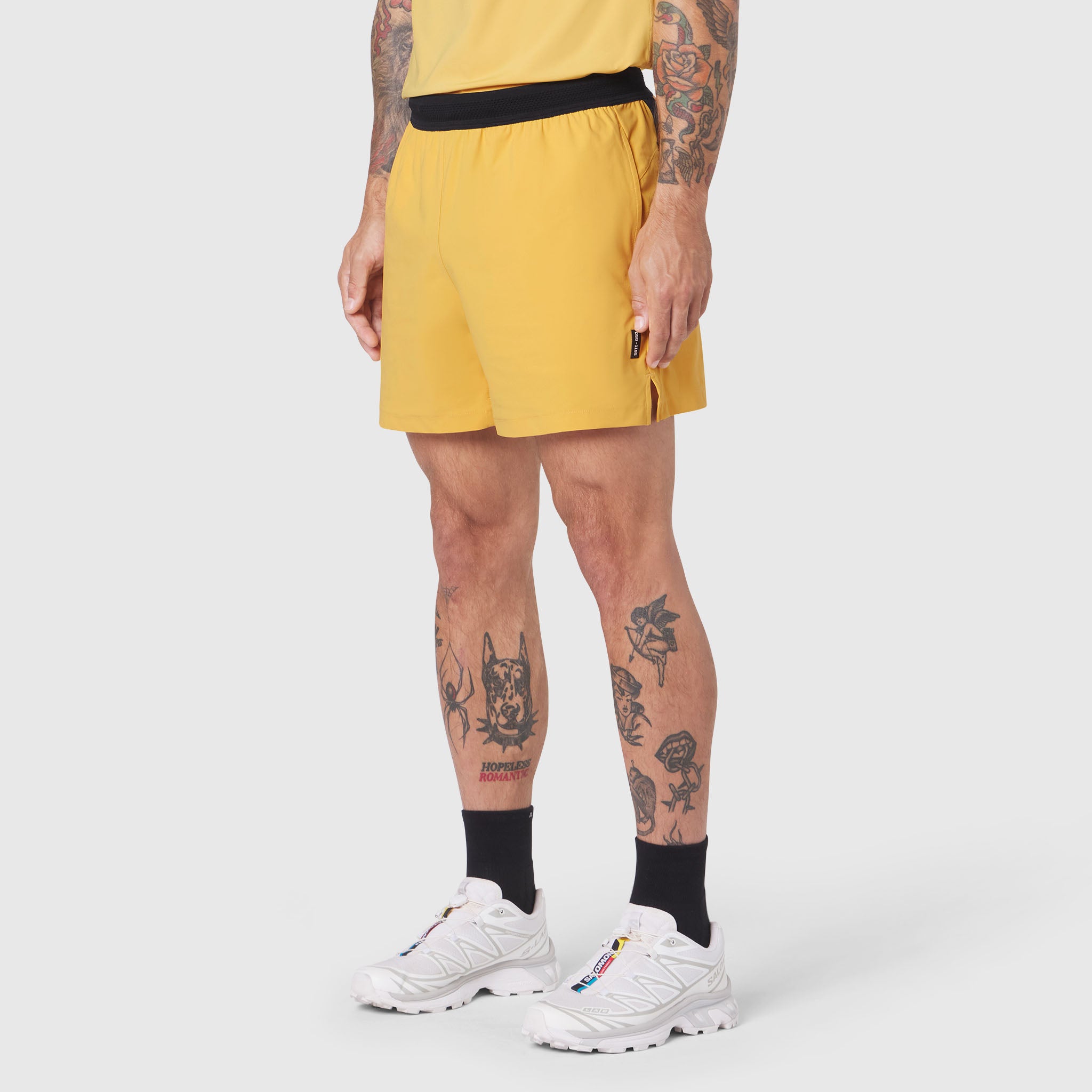 Tetra-Lite 5" Linerless Training Short in amber, worn by model with white sneakers