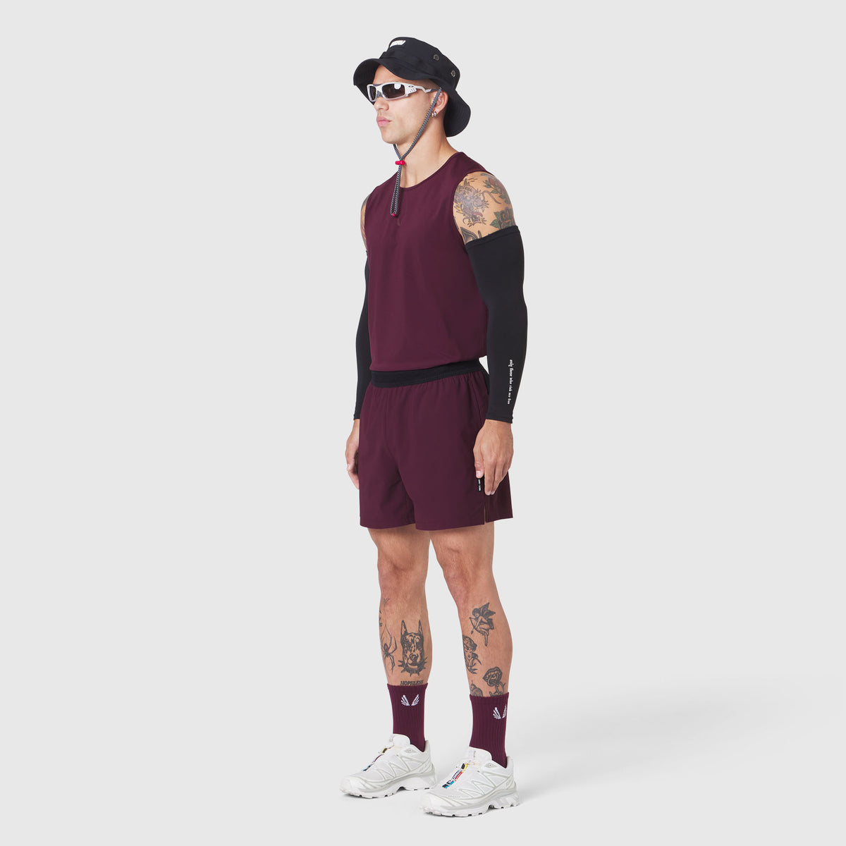 TETRA-LITE® 5" Linerless Training Short in merlot, modeled with matching long-sleeve top and socks