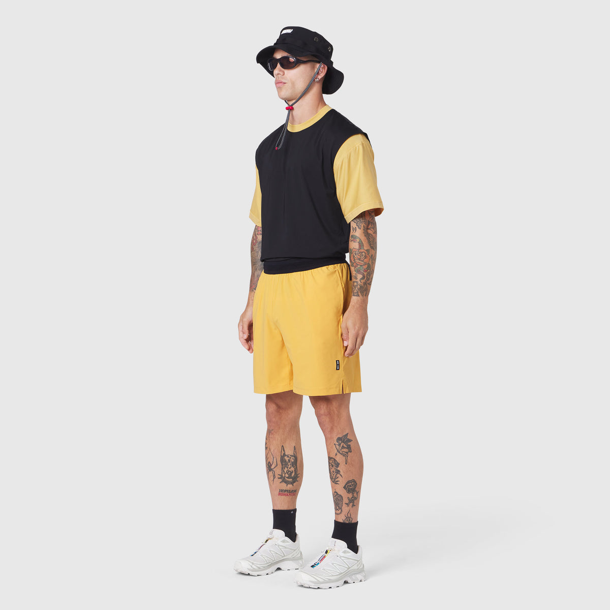 TETRA-LITE® 7" Linerless Training Short in Amber, modeled with black and yellow colorblock tee