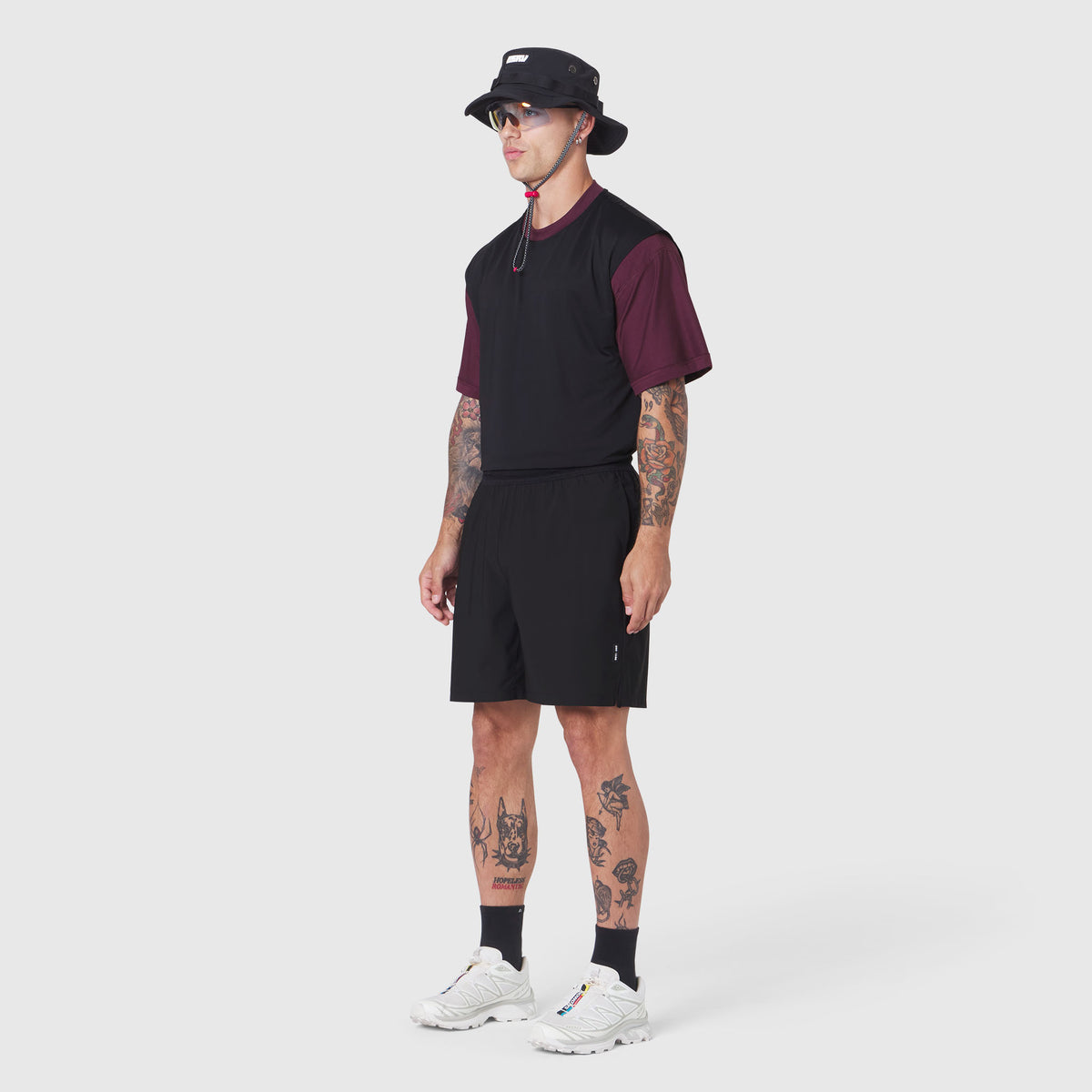 TETRA-LITE® 7" Linerless Training Short in black, modeled with maroon tee and bucket hat