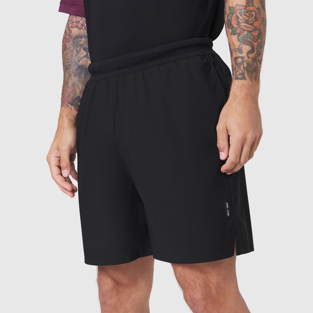 Black TETRA-LITE 7" linerless training shorts on model, side view