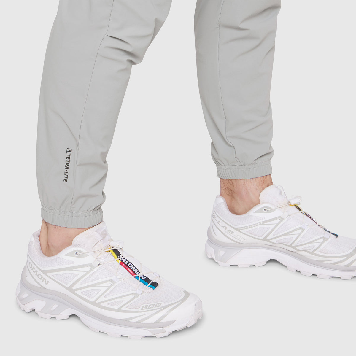 TETRA-LITE Training Jogger in slate grey worn with white sneakers, front view