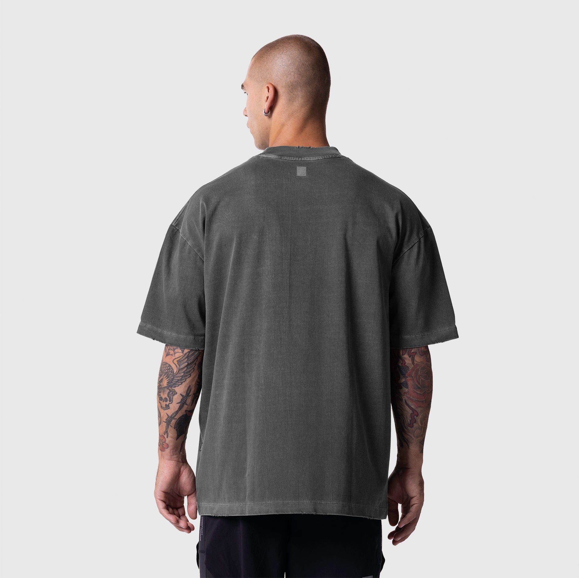 Model wearing Tech Essential Oversized Boxy Tee in Faded Grey, back view
