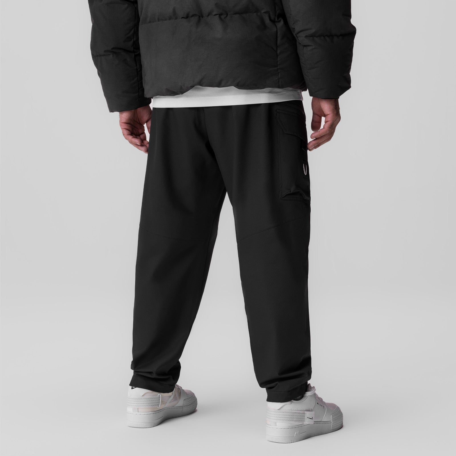 Black Tetra Weather-Ready City Pant worn by model from back view with white sneakers