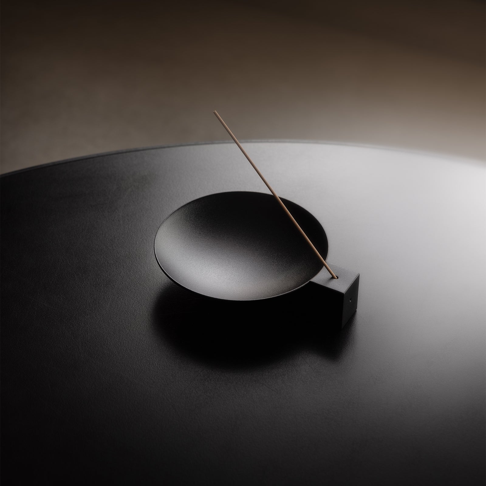 of ASRV x Walden Block Incense Holder in black, overhead view with incense stick