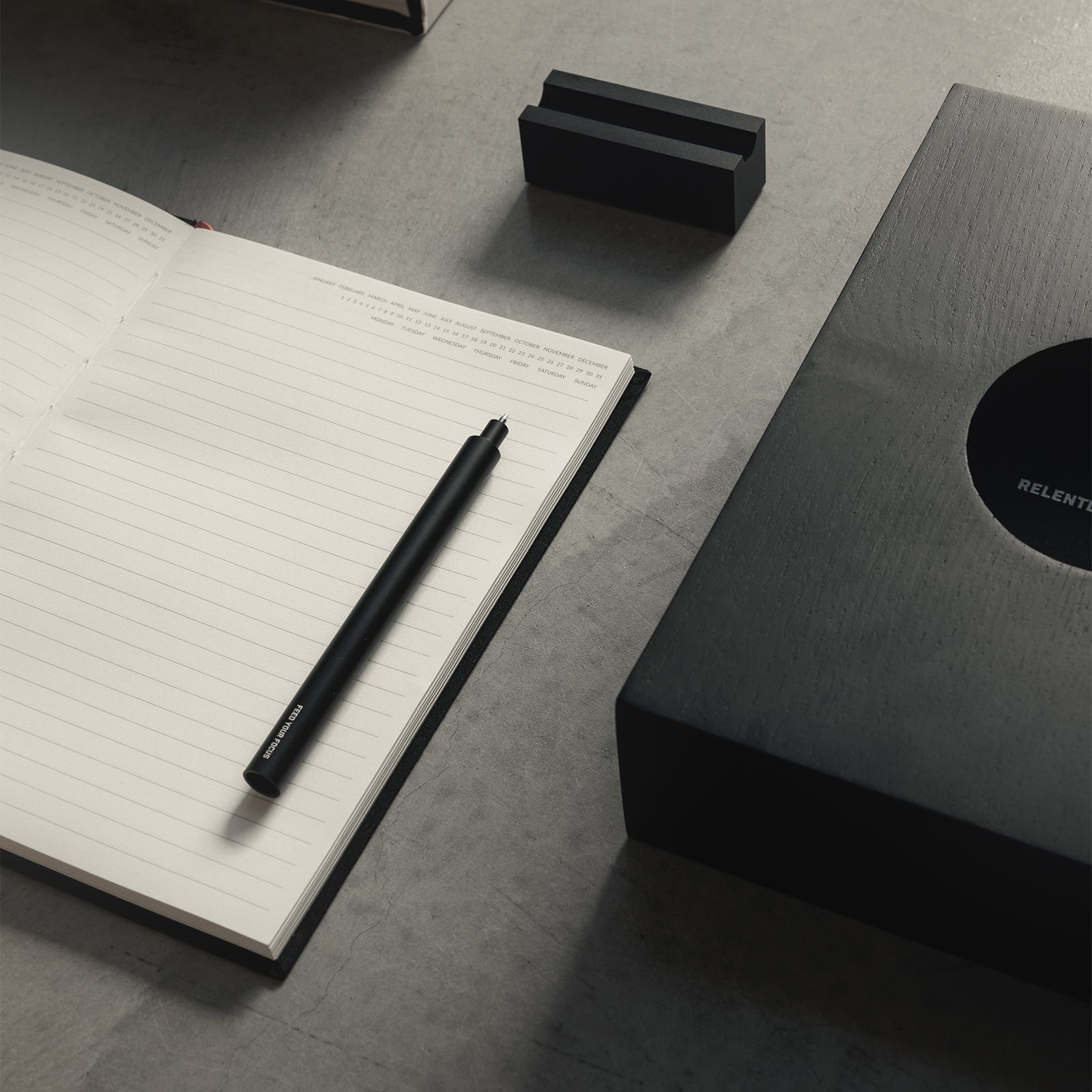 ASRV x Walden Journals & Case set with notebook, pen, and black case on grey surface