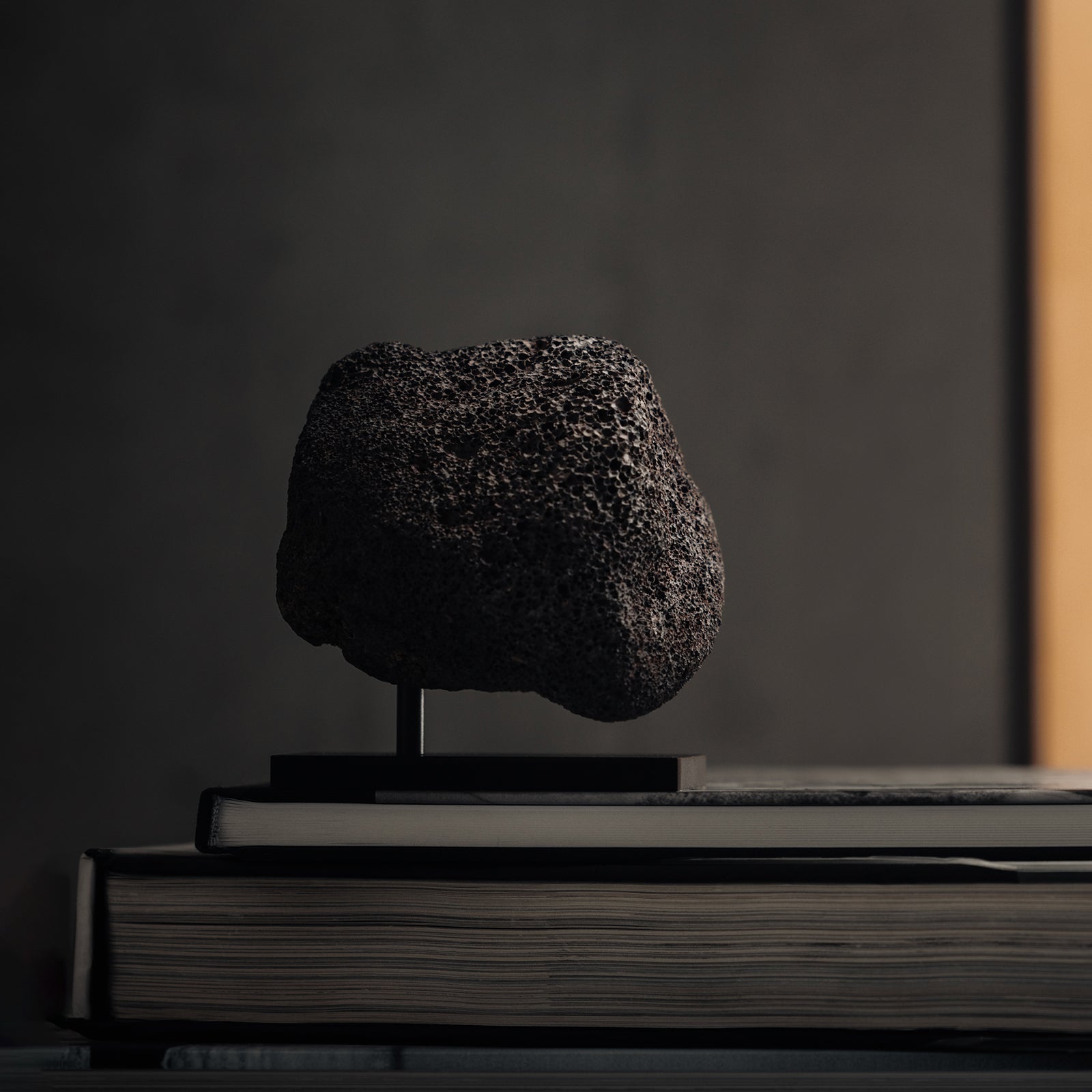 ASRV x Walden Lava Rock Essential Oil Diffuser in black, displayed on stacked books