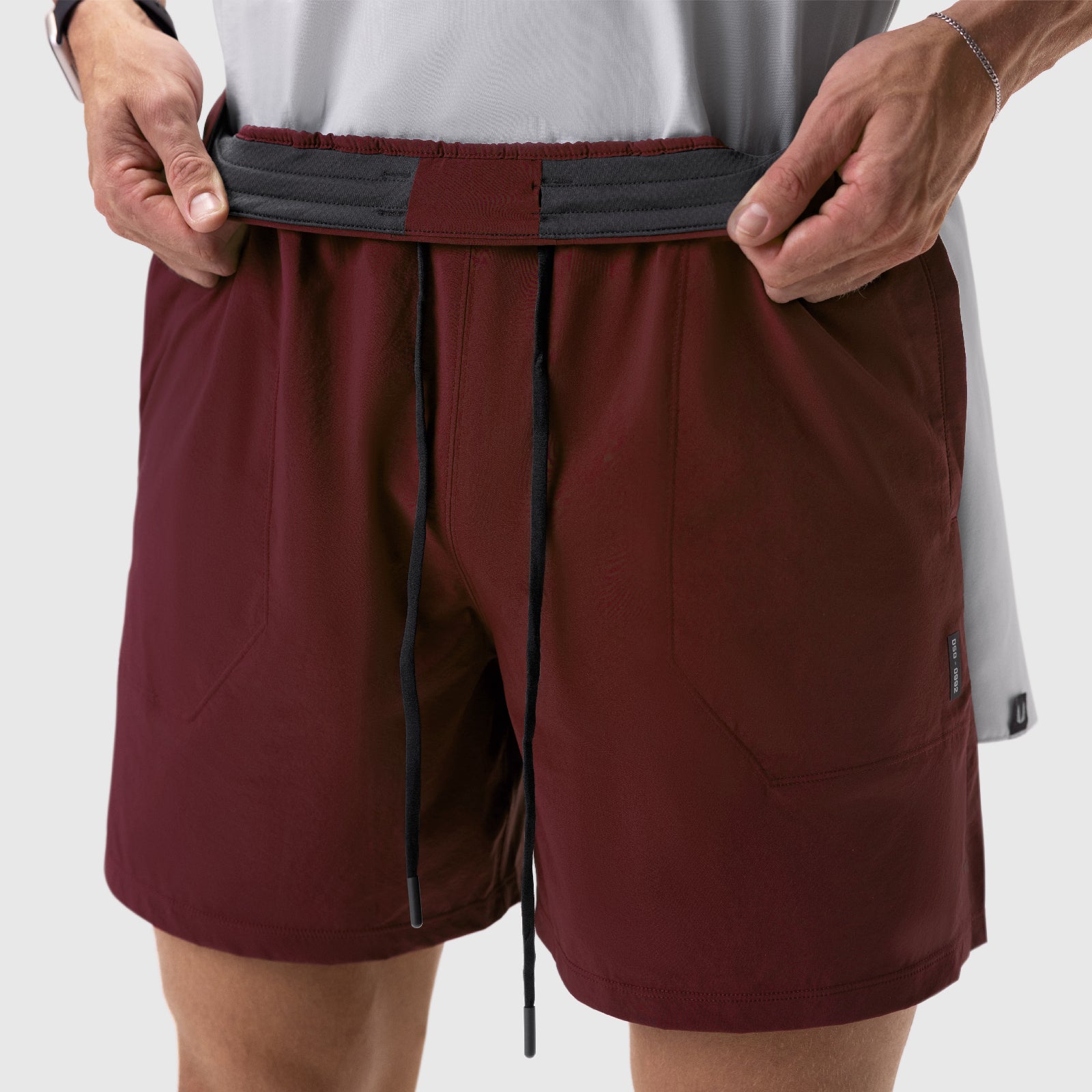 Aerotex™ 6" Training Short in crimson, worn by model adjusting waistband