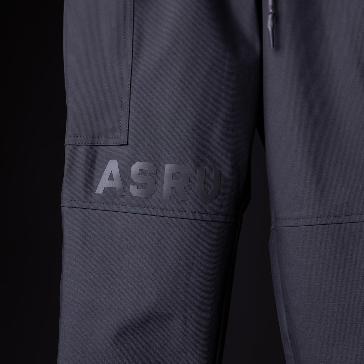 SP'20 Cargo Track Pant in charcoal gray, detail shot of leg pocket and ASRV branding
