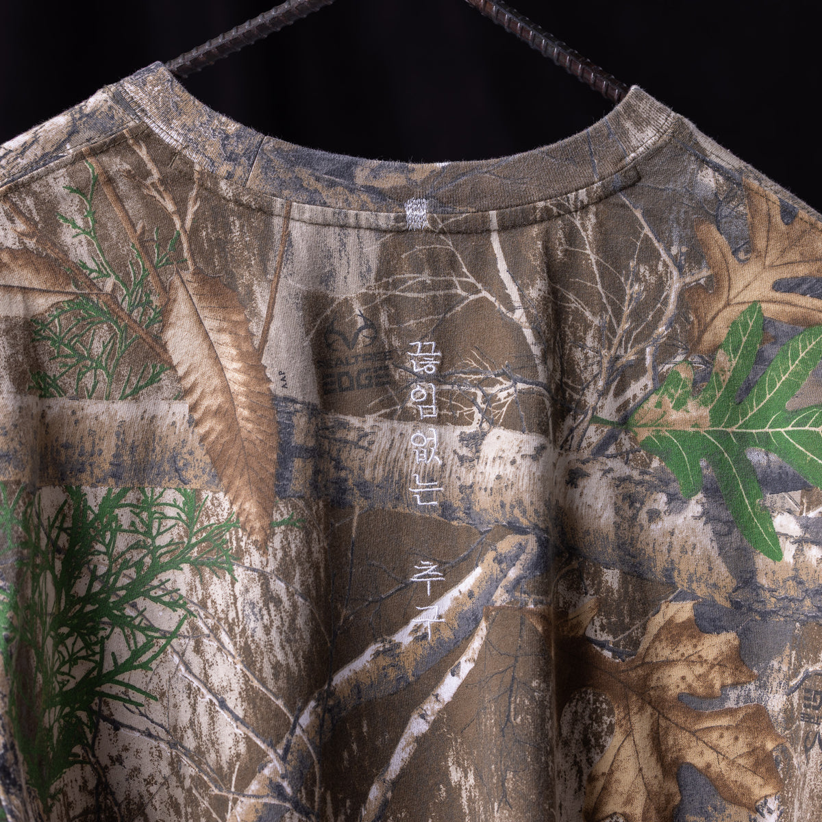 relaxed long sleeve tee in brown with nature print design and green leaf details, on hanger