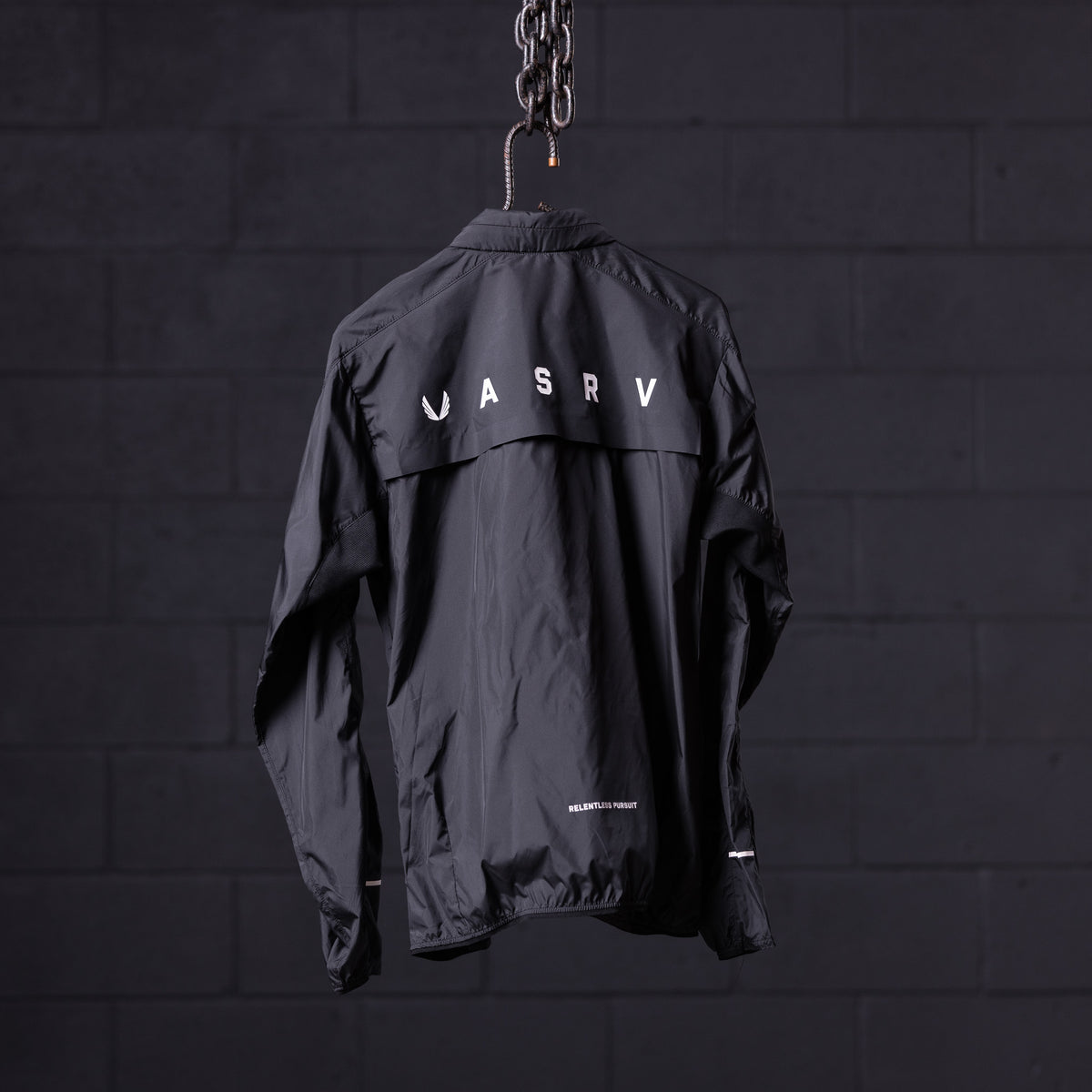 SP'22 Lightweight Windbreaker in black, displayed on hanger against dark background