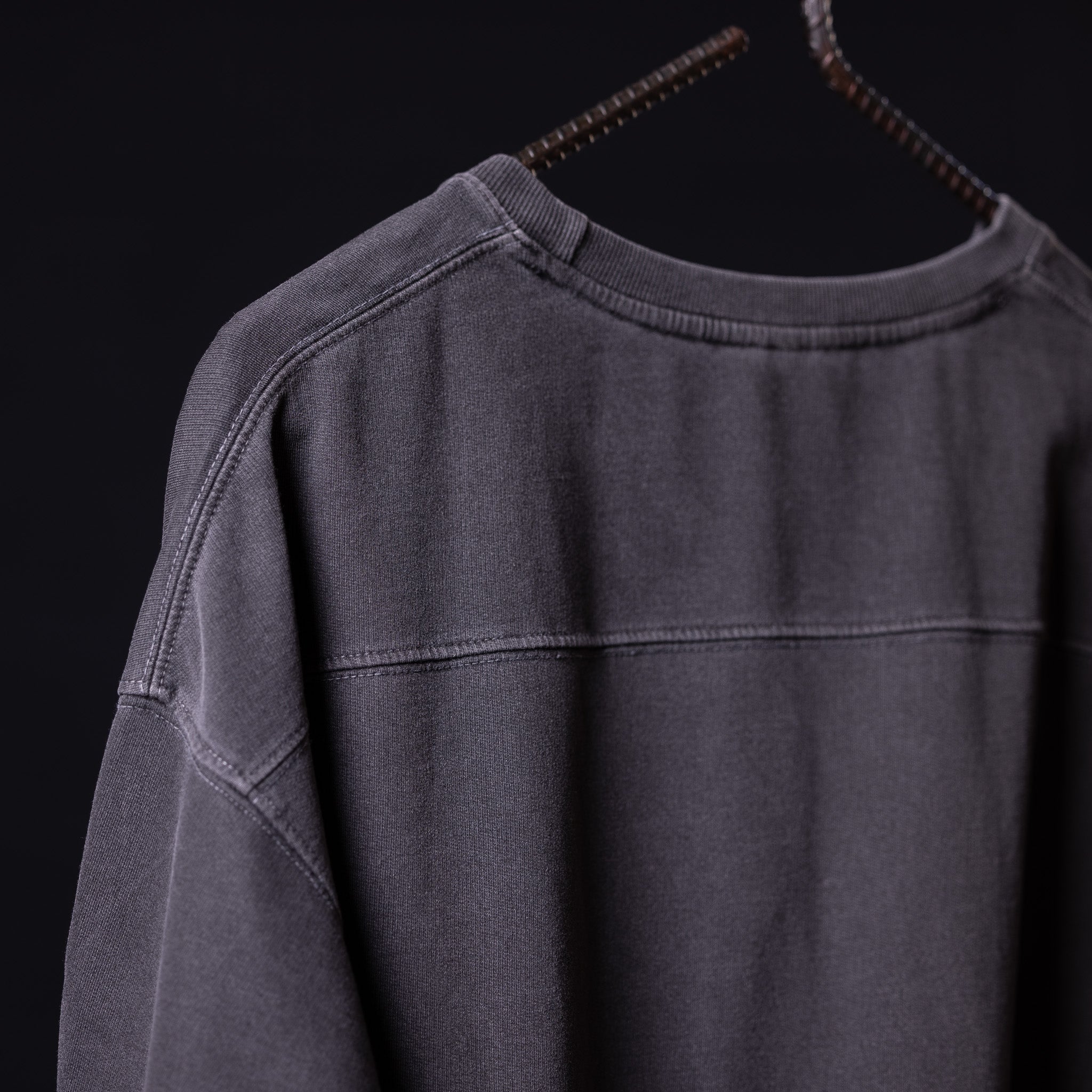 Stone washed oversized tee in charcoal gray, displayed on hanger from front angle